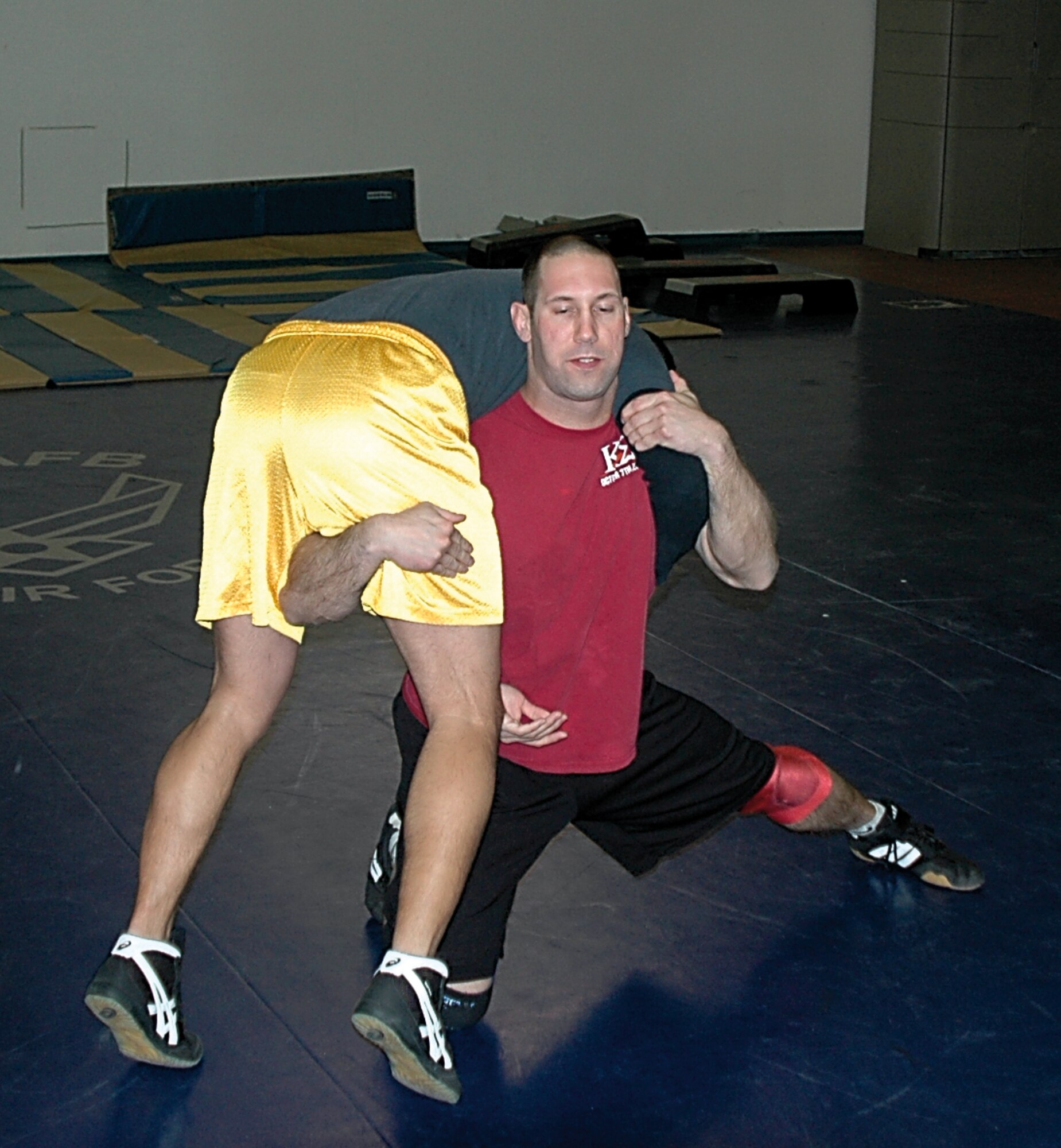 Airman 1st Class Robby Hedrick, 75th Air Base Wing Public Affairs, executes a high crotch takedown on Airman 1st Class Enrique Gaitan, 388th Equipment Maintenance Squadron Knowledge Operations manager, during a wrestling practice Jan. 23.