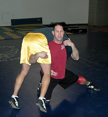 Airman 1st Class Robby Hedrick, 75th Air Base Wing Public Affairs, executes a high crotch takedown on Airman 1st Class Enrique Gaitan, 388th Equipment Maintenance Squadron Knowledge Operations manager, during a wrestling practice Jan. 23.