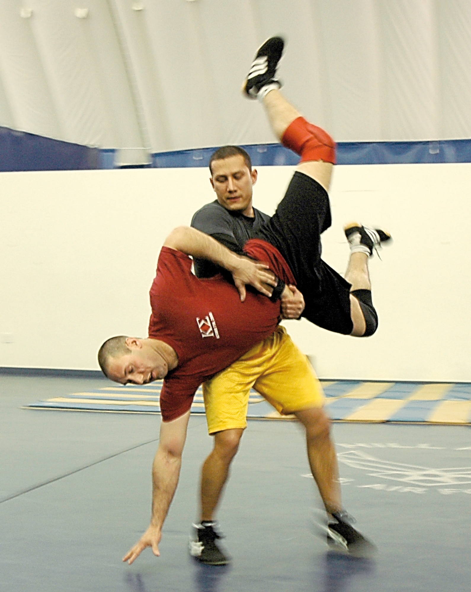 Airman 1st Class Enrique Gaitan, 388th Equipment Maintenance Squadron Knowledge Operations manager, performs a gut-wrench on Airman 1st Class Robby Hedrick, 75th Air Base Wing Public Affairs specialist, during a wrestling practice Jan. 23.