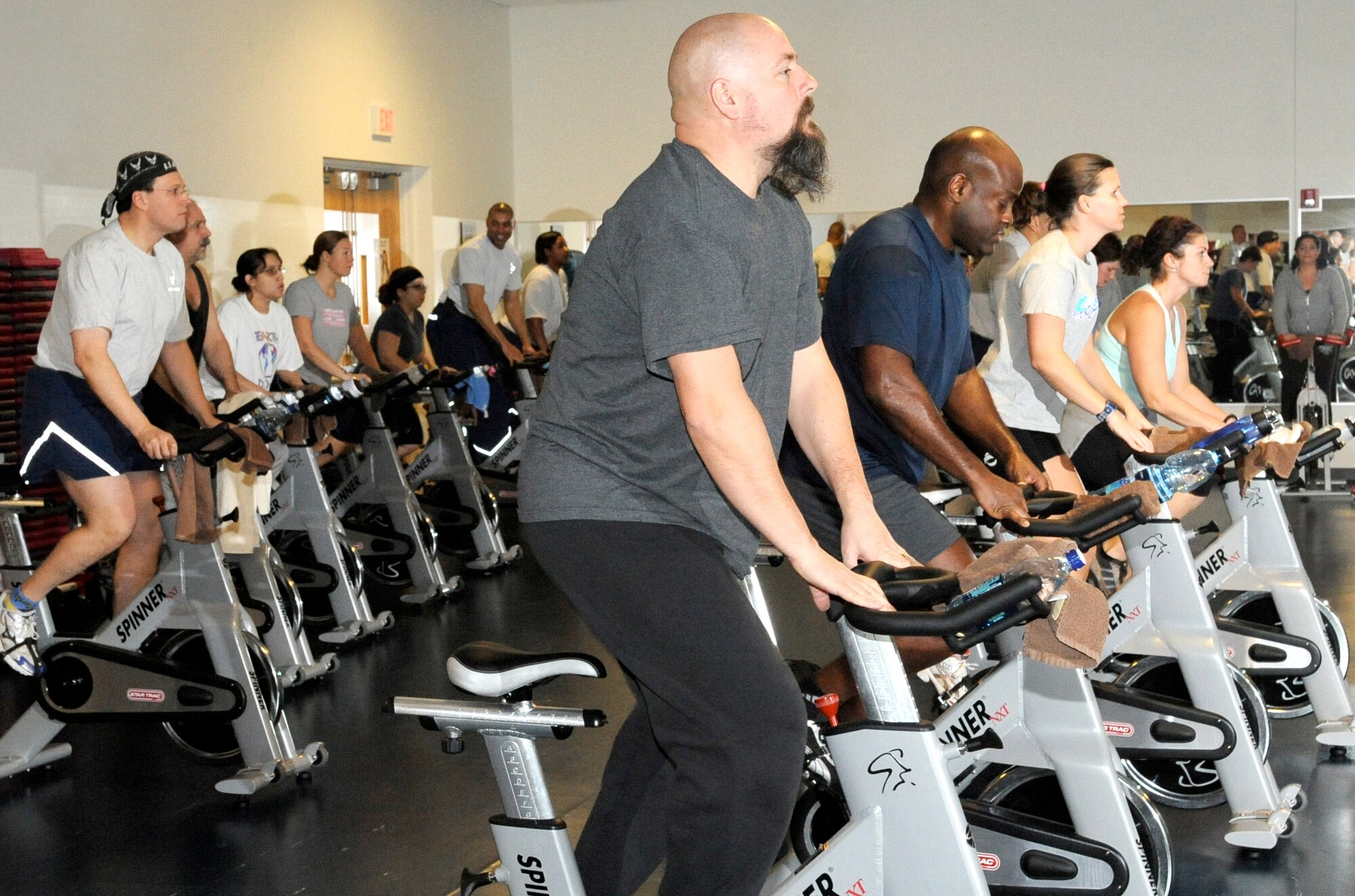 Time to tackle another hill: Spin class attendees adjust the resistance and stand up to keep on going. The spin class is just one of a few aerobic classes offered on various days and times at the McGuire Fitness Center. Class times and schedules are available on the 305th Services Squadron Web site - www.305services.com - or by calling the fitness center at (609) 754-6085. Classes are conducted on a first-come first-serve basis and can fill up quickly. (U.S. Air Force photo/Wayne Russell)
