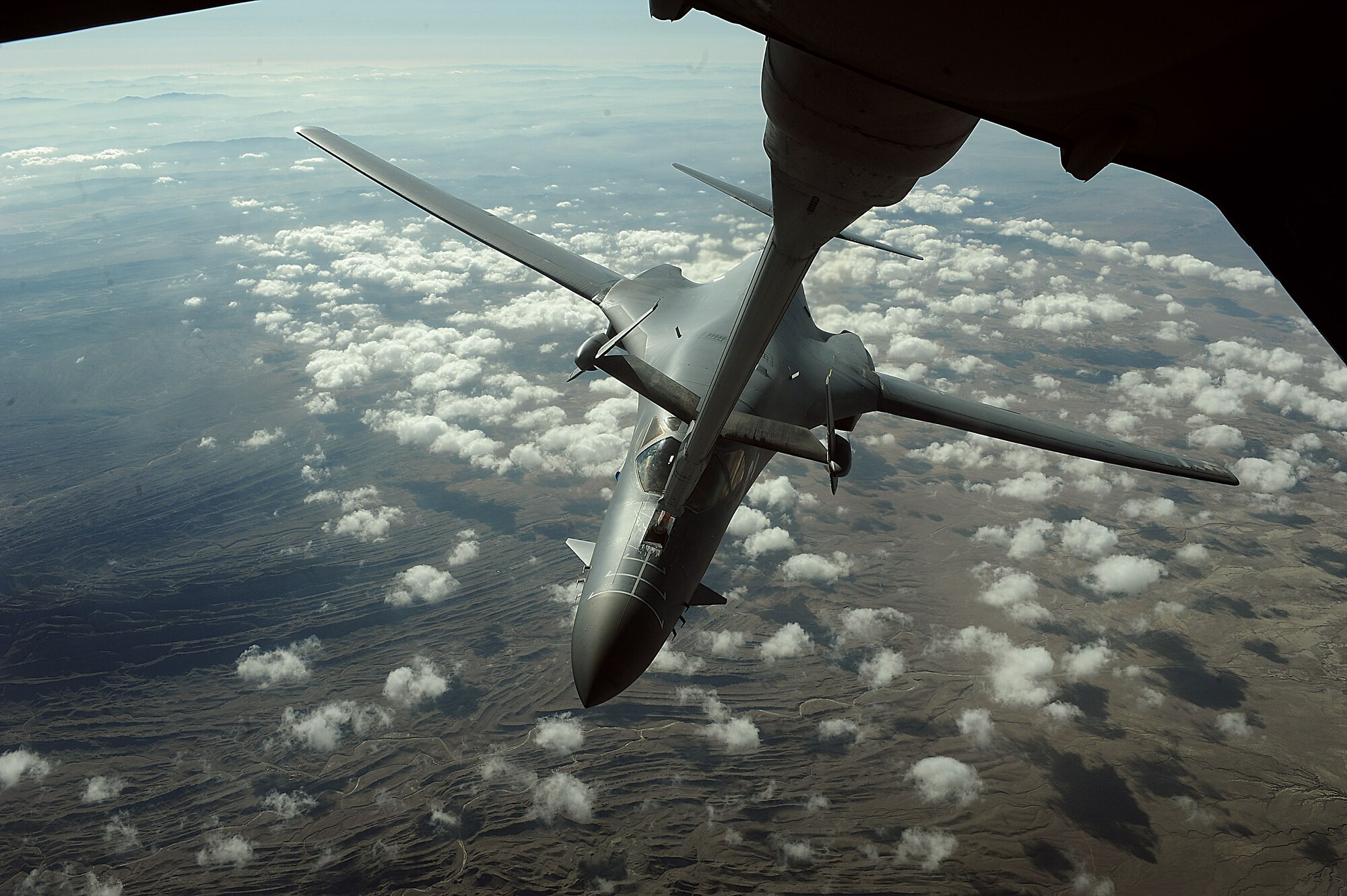A B-1B Lancer receives fuel over Afghanistan from a KC-10 Extender. B-1Bs can rapidly deliver massive quantities of precision and non-precision weapons against any adversary. The B-1B is assigned to the 34th Expeditionary Squadron and the KC-10 is assigned to the 908th Expeditionary Aerial Refueling Squadron. (U.S. Air Force photo/Staff Sgt. Aaron Allmon)  