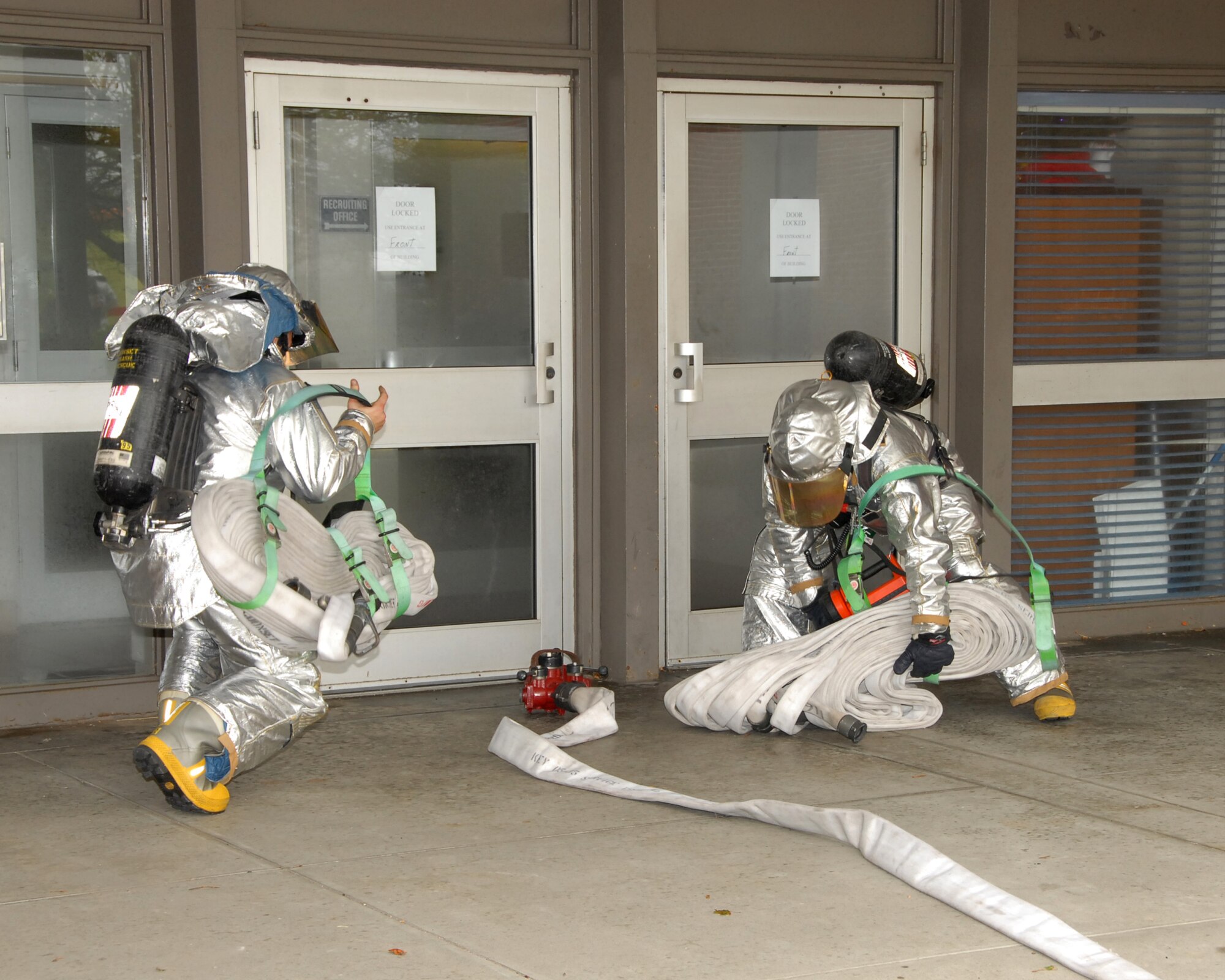 Members of the 143d Airlift Wing Fire Department respond to a call of smoke in the headquarters building during an annual Anti-Terrorism Exercise held at the 143d AW, Quonset Air National Guard Base, North Kingstown, Rhode Island. (USAF photo by MSgt John McDonald) (Released)