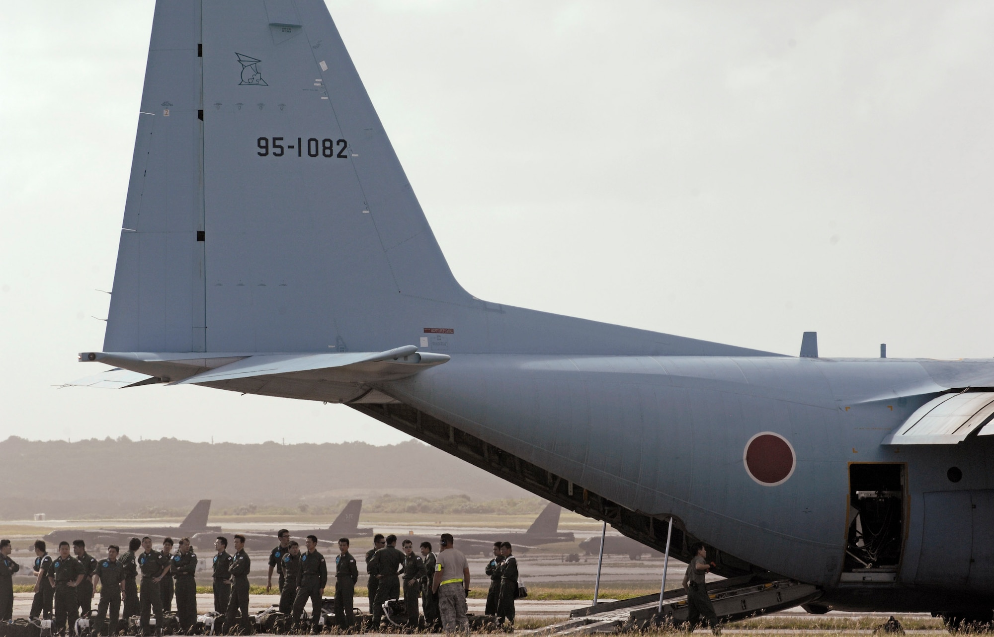 Japan Air Self Defense Force members wait outside of their C-130 after arriving Jan. 27 at Andersen Air Force Base, Guam. More than 60 JASDF members arrived in three C-130s to participate in Exercise Cope North 09-1, a regularly scheduled exercise scheduled for Feb. 2 through 13. Cope North is designed to enhance U.S. and Japanese air operations in defense of Japan. JASDF F-2s from Tsuiki Air Base, Japan, and E-2Cs from Misawa AB, Japan, will join forward deployed U.S. Air Force F-16 Fighting Falcons from Eielson Air Force Base, Alaska, B-52 Stratofortress' currently deployed to Andersen AFB, and Navy EA-6B from VAQ-136 Carrier Air Wing Five, Atsugi, Japan, will participate in this year's exercise with a focus on interoperability. (U.S. Air Force photo/Master Sgt. Kevin J. Gruenwald) 
