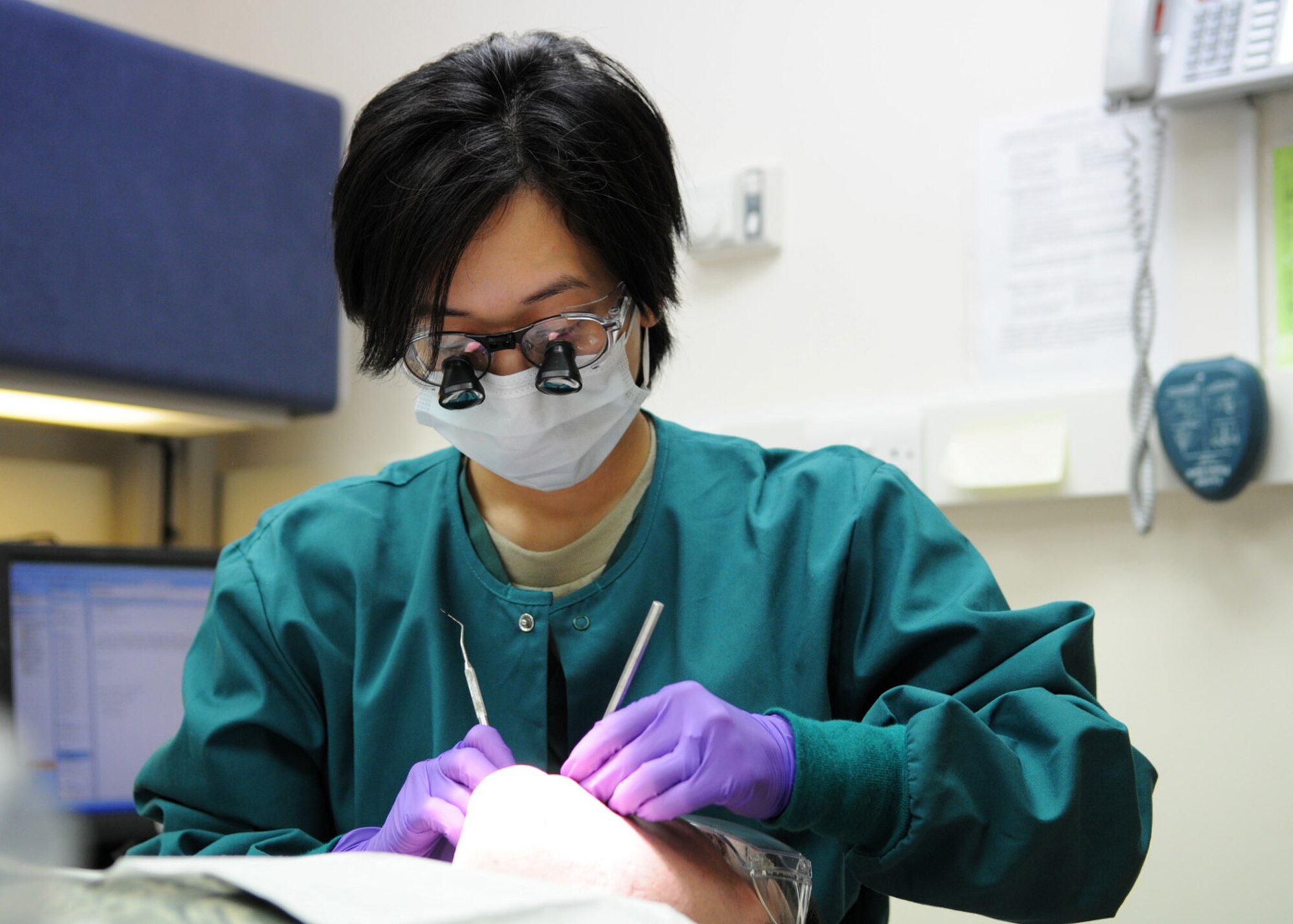 Maj. (Dr.) Elizabeth Kutner, a dentist from the 48th Dental Squadron, performs a pre-deployment examination on Staff Sgt. Nicholas Beebe Jan. 15, 2009, at RAF Mildenhall, England. Maj. Kutner and her team perform more than 160 dental procedures weekly for active duty service members stationed here. (U.S. Air Force photo by Staff Sgt. Jerry Fleshman)