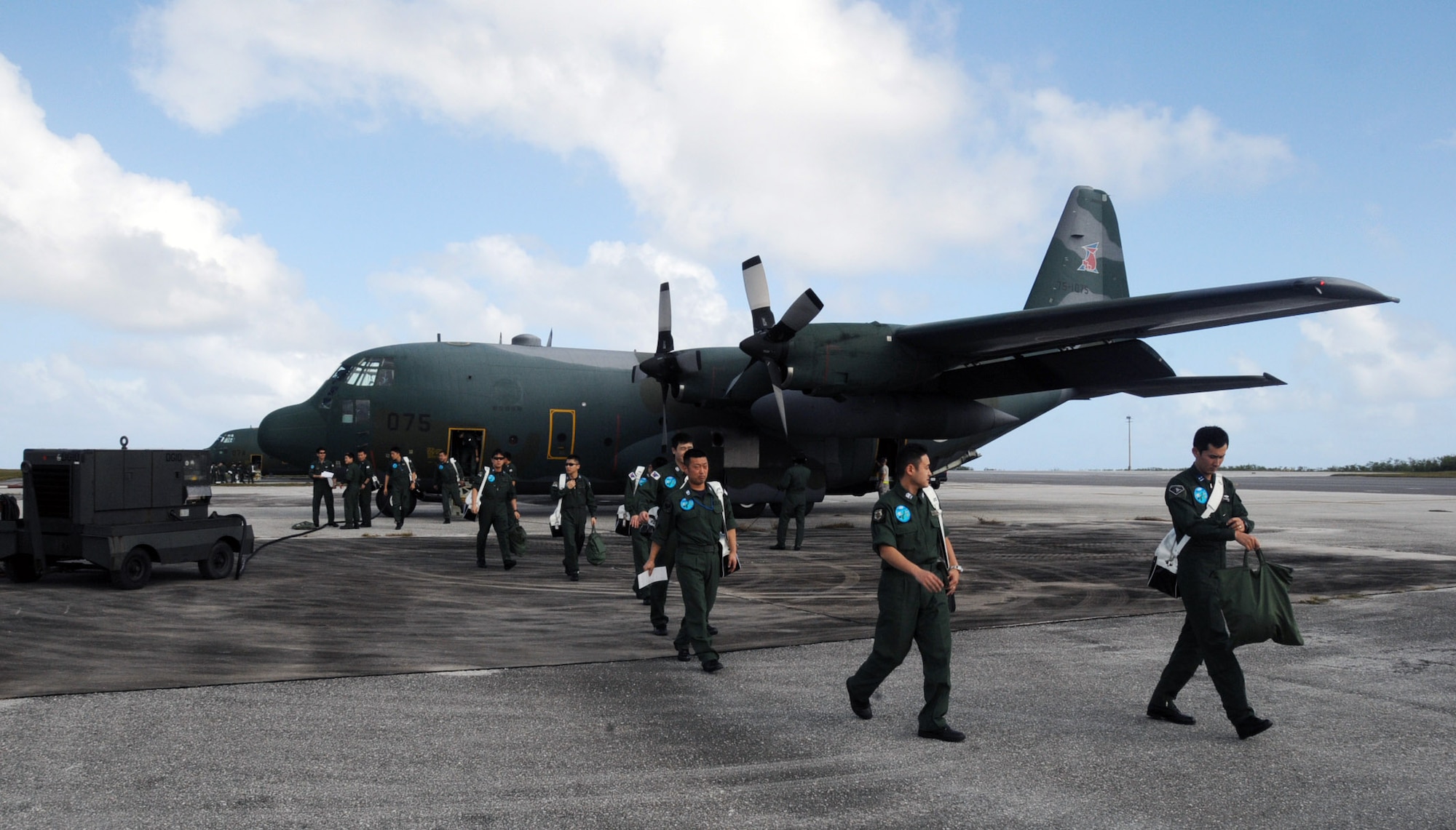 Japan Air Self Defense Force members offload from a C-130 after arriving Jan. 27 at Andersen Air Force Base, Guam. More than 60 JASDF members arrived in three C-130s to participate in Exercise Cope North 09-1, a regularly scheduled exercise scheduled for Feb. 2 through 13. Cope North is designed to enhance U.S. and Japanese air operations in defense of Japan. (U.S. Air Force photo/Senior Airman Ryan Whitney) 
