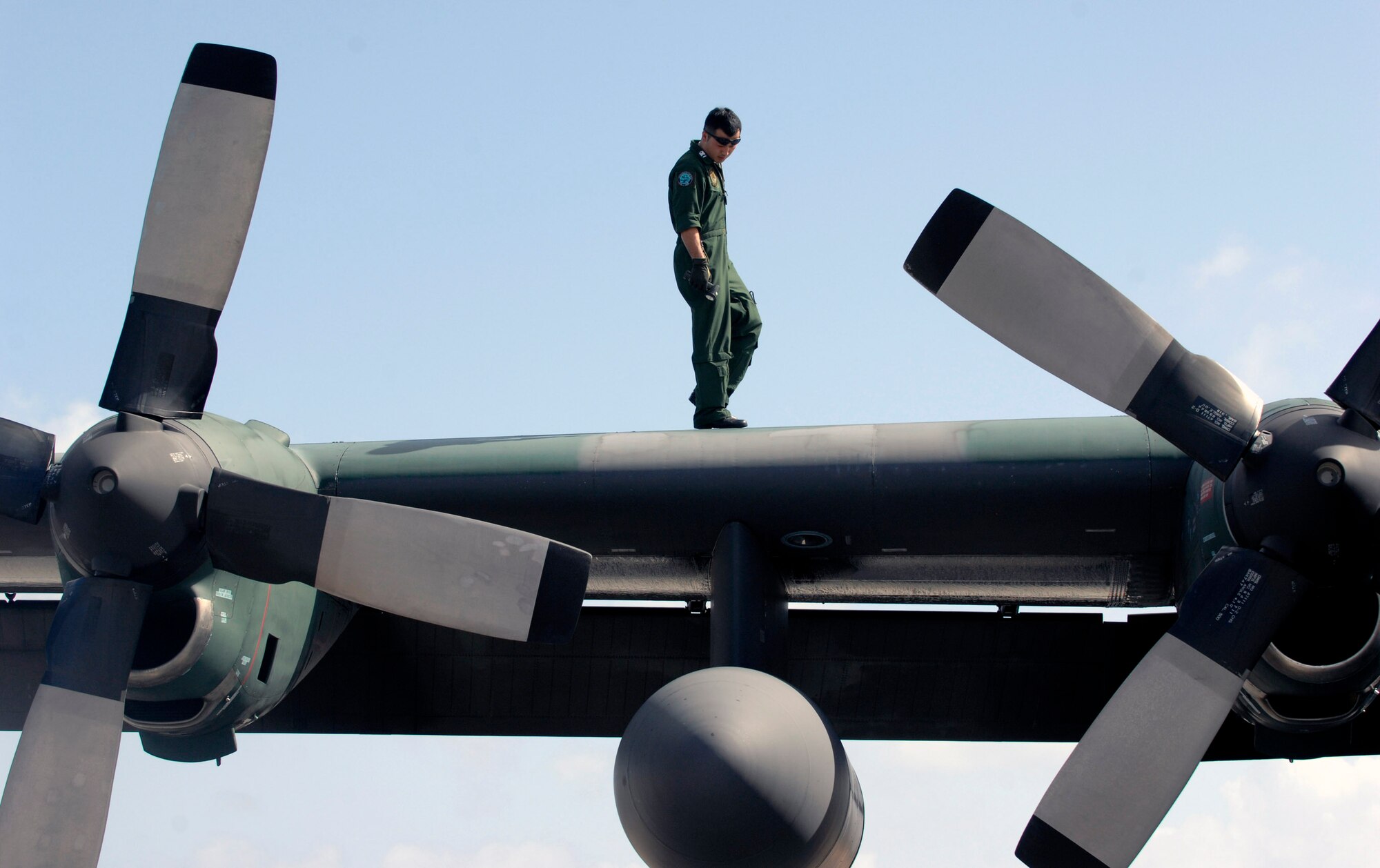 A Japan Air Self Defense Force member performs post flight maintenance on a JASDF C-130 after its arrival for participation in Exercise Cope North 09-1 Jan. 27 at Andersen Air Force Base, Guam. More than 60 JASDF members arrived in three C-130s to participate in the regularly scheduled exercise scheduled for Feb. 2 through 13. Cope North is designed to enhance U.S. and Japanese air operations in defense of Japan. (U.S. Air Force photo/Master Sgt. Kevin J. Gruenwald) 
