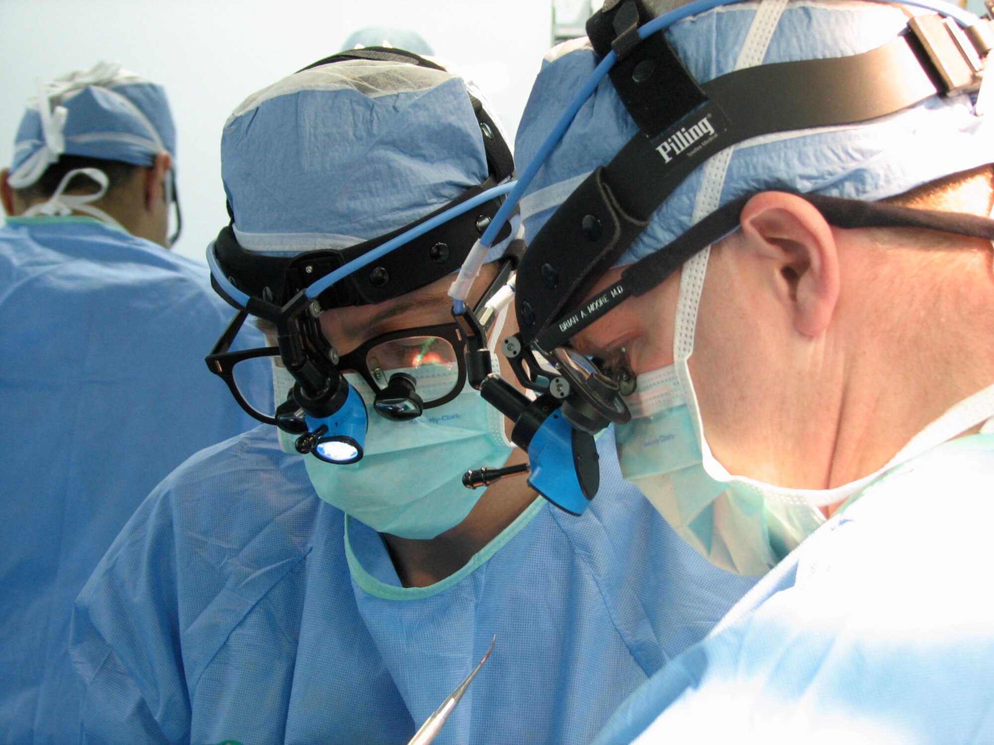 Dr. (Maj.) Brian Moore, a head and neck surgical oncologist from Eglin AFB, Fla. operates on a patient with Lt. Col. Ted Ferguson, a U.S. Army plastic surgeon while deployed to Kabul, Afghanistan. (courtesy photo) 