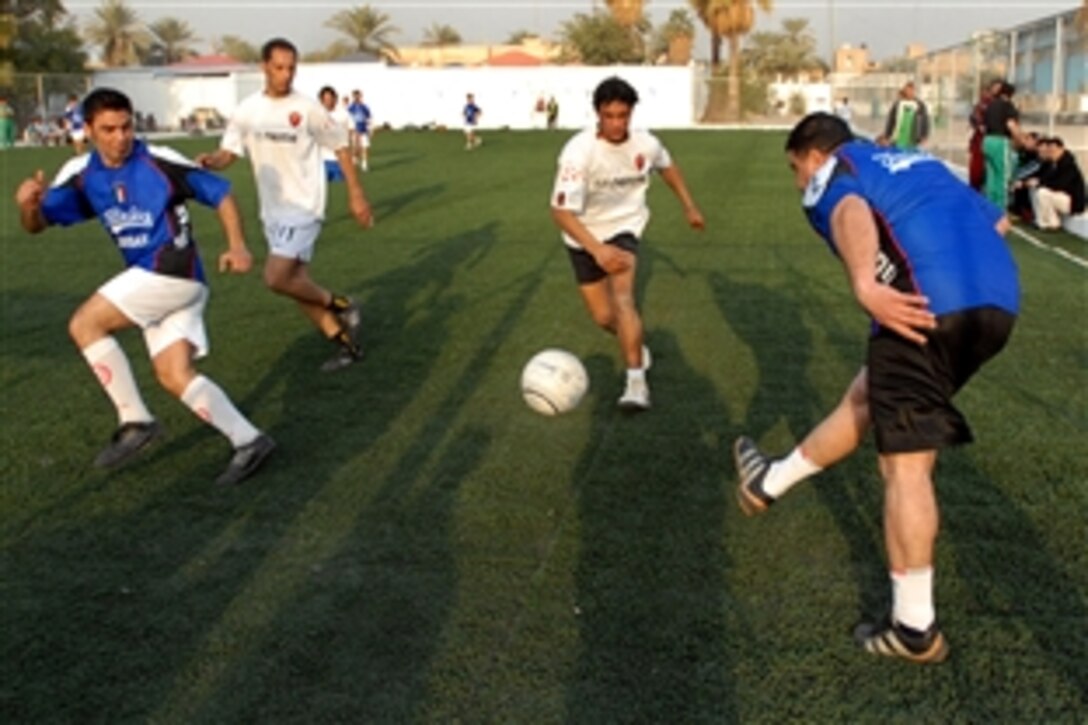 A member of the Adhamiyah, Iraq, soccer team passes the ball to his teammate during a friendly game between teams from northeastern Baghdad’s Adhamiyah and Kadhamiyah districts, Jan. 27, 2009. The game was played as part of the festivities marking the reopening of the Adhamiyah Sports Complex. 
