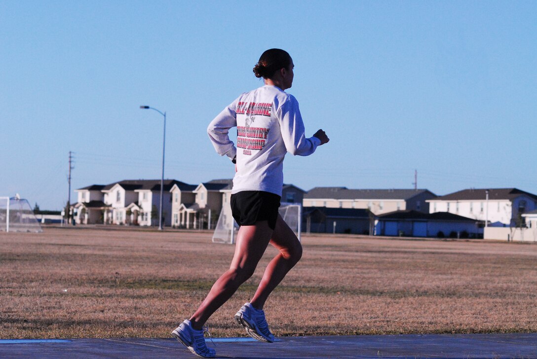 1st Lt. Erin Demchko, Marine Wing Support Squadron 371 assistant logistics officer, runs around a track at the Marine Corps Air Station in Yuma, Ariz., Jan. 28, 2009. Demchko is scheduled to compete at the 2010 Armed Forces Cross-Country Championship in Spokane, Wash., on Feb. 13, 2010. "It's the physical mission," said Demchko. "Its's not just a military race. In essence, we go out, and we're the face of the Marine Corps."