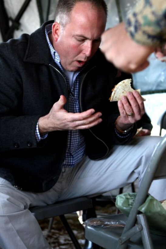 A local community council member tastes a beef enchilada Meal-Ready-to-Eat during a brief gathering here, Jan. 29. Several civilians came aboard the installation to get a brief display of military life and to highlight the importance of training at Fort A.P. Hill, a base nicknamed “Where America’s military sharpens its combat edge.” (Official U.S. Marine Corps photo by Lance Cpl. Casey Jones) (RELEASED)