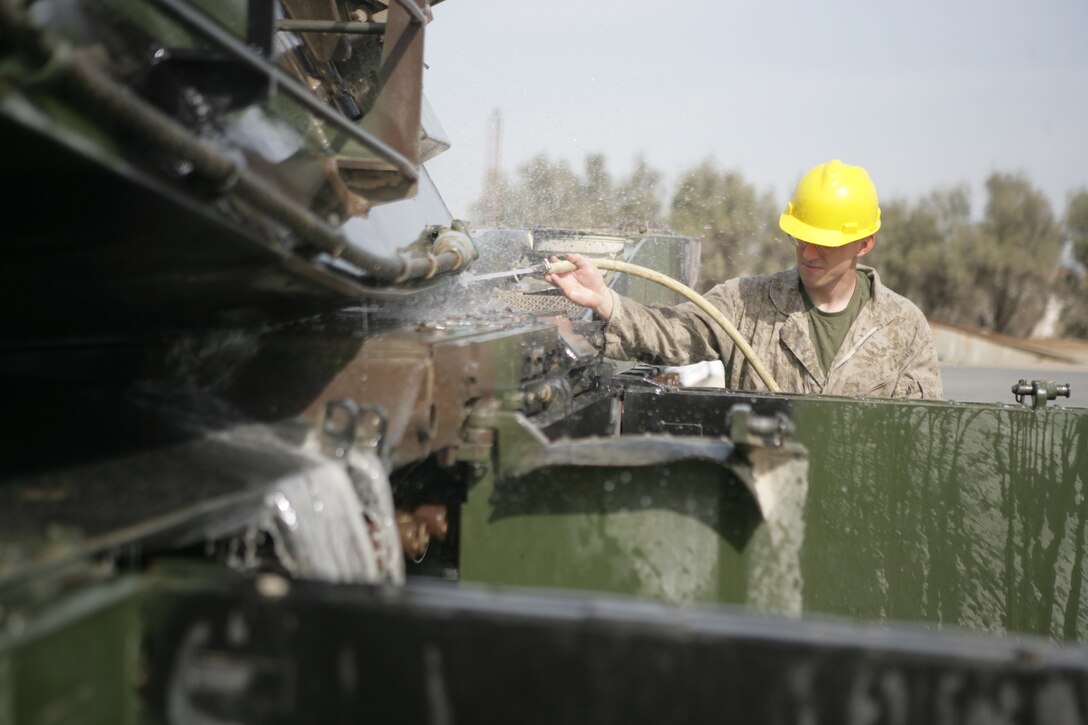 (Jan. 29, 2009) - Cpl. Jason Broz, an M1A1::r::::n::crewman with Battalion Landing Team 2/6, 26th Marine Expeditionary Unit,::r::::n::washes down a tank, January 29, 2009. The MEU-wide wash down, the last::r::::n::major operation before the MEU leaves for the US, was conducted in order::r::::n::to prevent any foreign contaminants from entering the United States.::r::::n::(Official USMC photo by Cpl. Jason D. Mills)(Released)