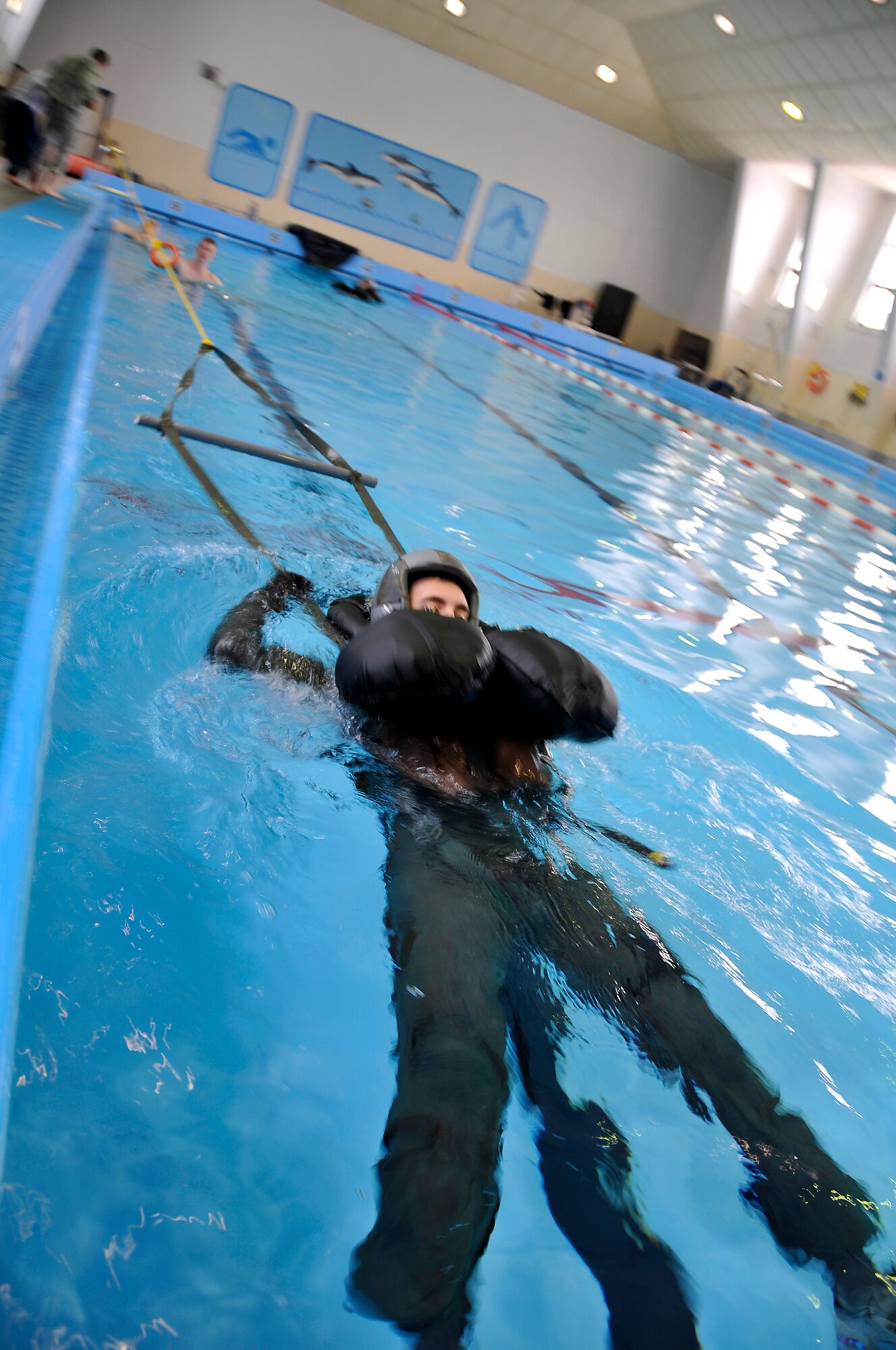 MISAWA AIR BASE, Japan -- Capt. Anthony Eschliman, 35th Aerospace Medicine Squadron, is being pulled through the water to simulate parachute drag during water survivial training Jan. 21, 2009.  The training is conducted by Survival, Evasion, Resistance and Escape instructors annually.  (U.S. Air Force photo by Senior Airman Chad Strohmeyer)