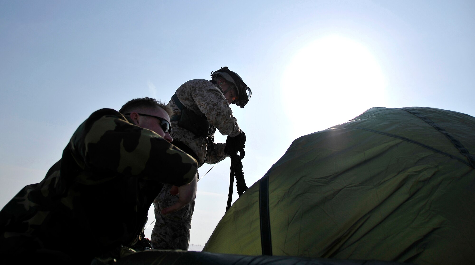 MISAWA AIR BASE, Japan -- Tech. Sgt. Louis Distelzwieg, Kadena Air Base, 31st Rescue Squadron pararescueman, packs up his parachute after jumping out of a C-130 Hercules at 1,250 feet during training Jan. 22, 2009.  This training is required for instructors to keep their qualification.  (U.S. Air Force photo by Senior Airman Chad Strohmeyer)