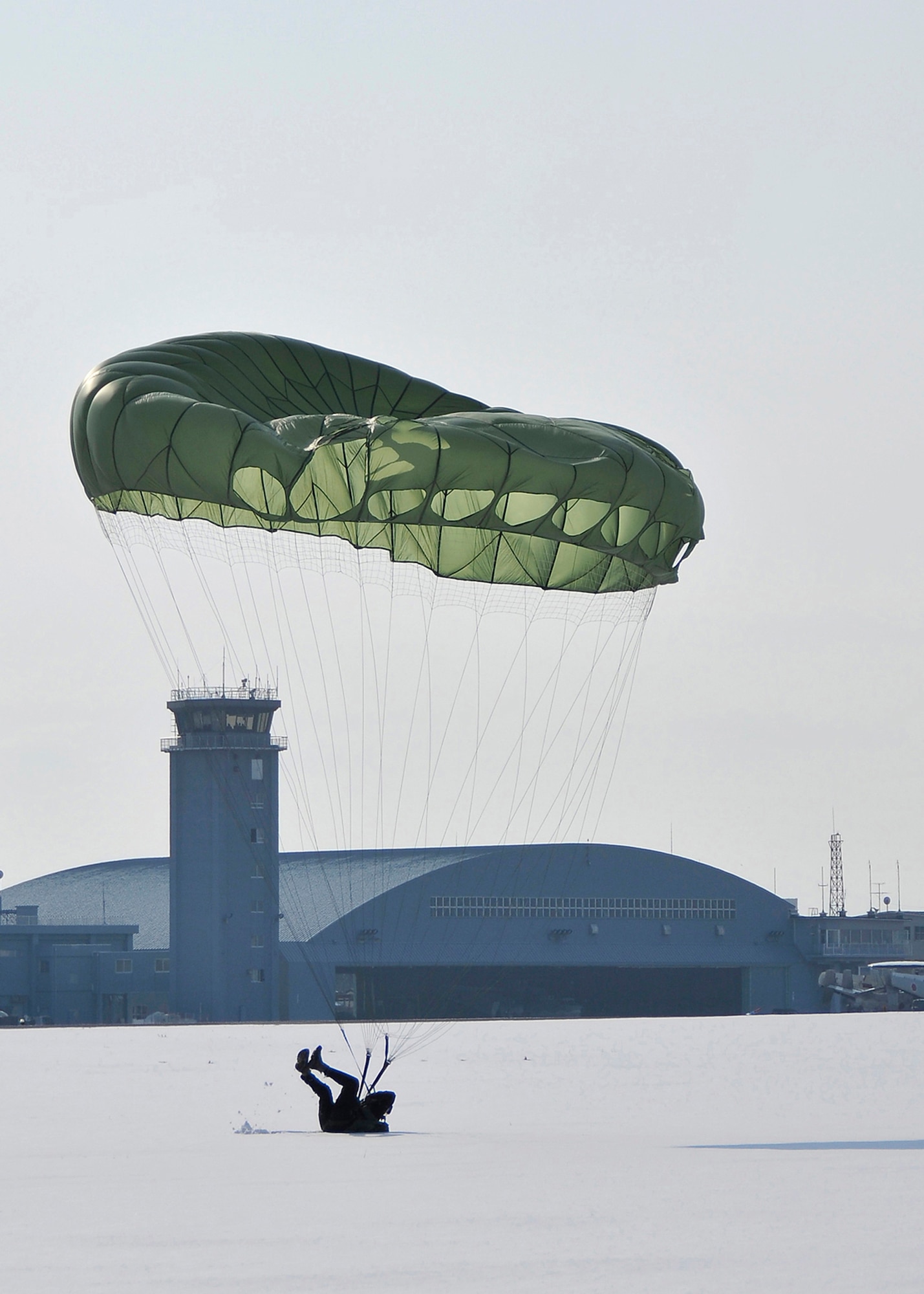 MISAWA AIR BASE, Japan -- As part of training, Tech. Sgt. Greg Adams 35th Operations Support Squadron Survival, Evasion, Resistance and Escape instructor, lands on the runway infield after parachuting out of a C-130 Hercules at 1,250 feet Jan. 22, 2009.  The training is conducted to help refamiliarize SERE instructors with the proper jump techniques.  (U.S. Air Force photo by Senior Airman Chad Strohmeyer)