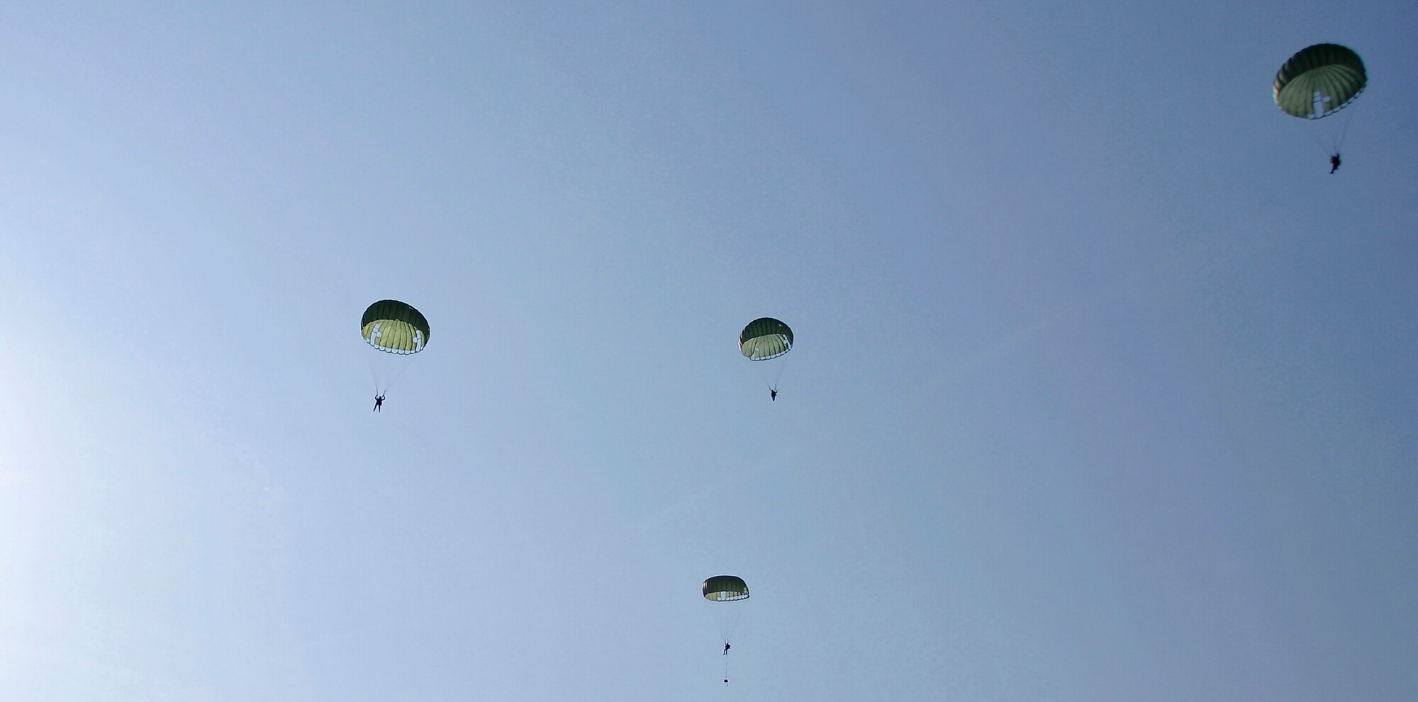 MISAWA AIR BASE, Japan -- Survival, Evasion, Resistance and Escape instructors and a pararescueman parachute out of a C-130 Hercules at 1,250 feet during training Jan. 22, 2009.  The training is conducted to help refamiliarize SERE instructors with the proper jump techniques.  (U.S. Air Force photo by Senior Airman Chad Strohmeyer)
