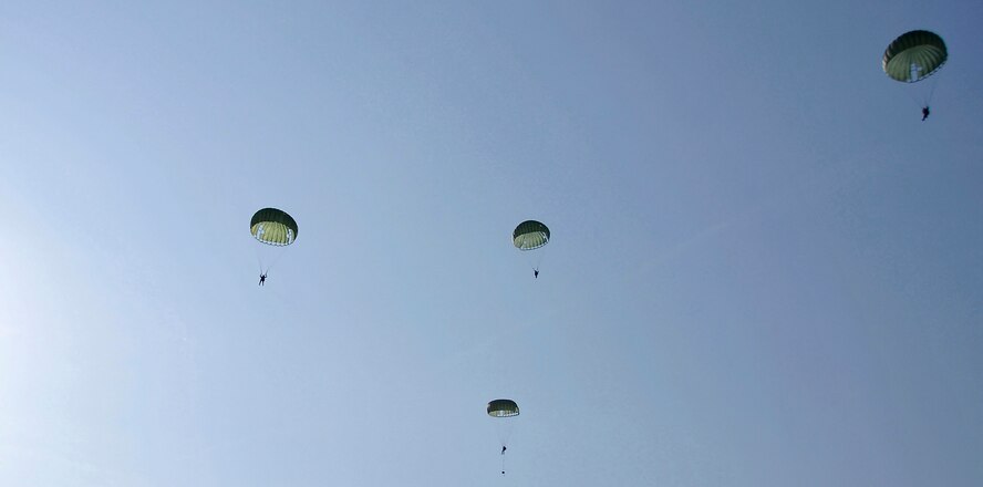 MISAWA AIR BASE, Japan -- Survival, Evasion, Resistance and Escape instructors and a pararescueman parachute out of a C-130 Hercules at 1,250 feet during training Jan. 22, 2009.  The training is conducted to help refamiliarize SERE instructors with the proper jump techniques.  (U.S. Air Force photo by Senior Airman Chad Strohmeyer)