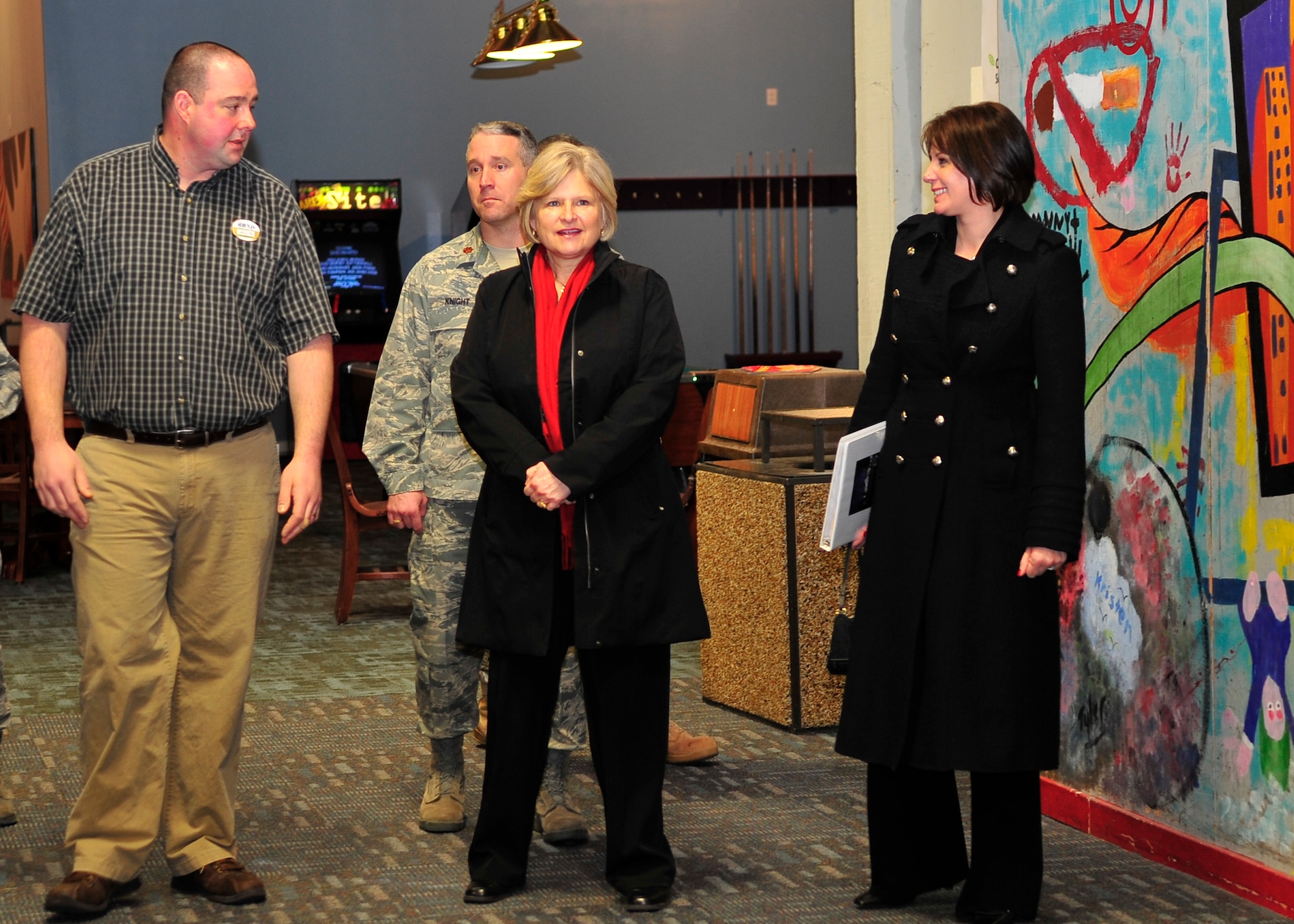 FAIRCHILD AIR FORCE BASE, Wash. – Kathy Scott, wife of Maj. Gen. Winfield Scott, 18th Air Force commander, speaks with Fairchild FunSpot manager Jason McCatheren, and Mari Thomas, wife of Col. Robert Thomas, 92nd Air Refueling Wing commander, as Maj. Jason Knight, 92nd Mission Support Squadron commander, looks on at the FunSpot Jan. 29. (U.S. Air Force photo / Airman 1st Class Melissa Barnett)