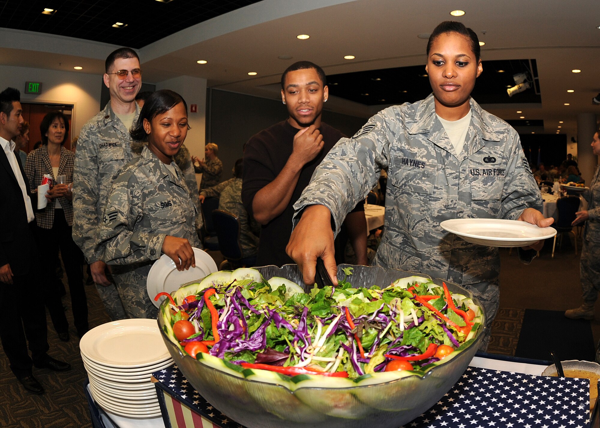 Staff Sgt. Meegan Haynes, 61st Communications Squadron, who recently returned from a deployment from Qatar in the Middle East, helps herself to some salad at a luncheon held after the "SMC Welcome Home Airmen Celebration" at the Gordon Conference Center, Jan. 29. (Photo by Stephen Schester)
