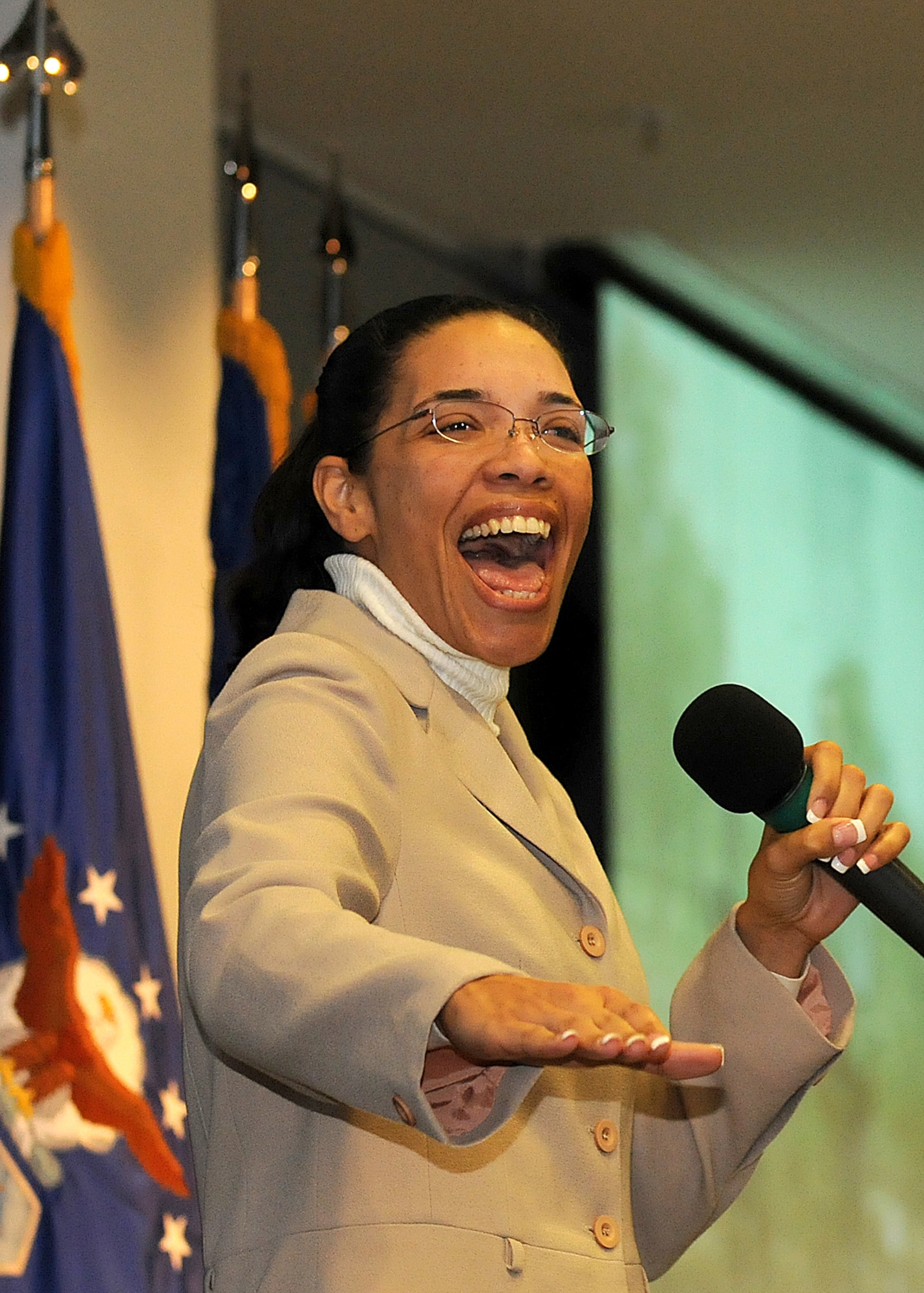 Felicia Brown, Contracting office, performs the song Proud to be an American for the troops during the "SMC Welcome Home Airmen Celebration" at the Gordon Conference Center, Jan. 29. (Photo by Stephen Schester)