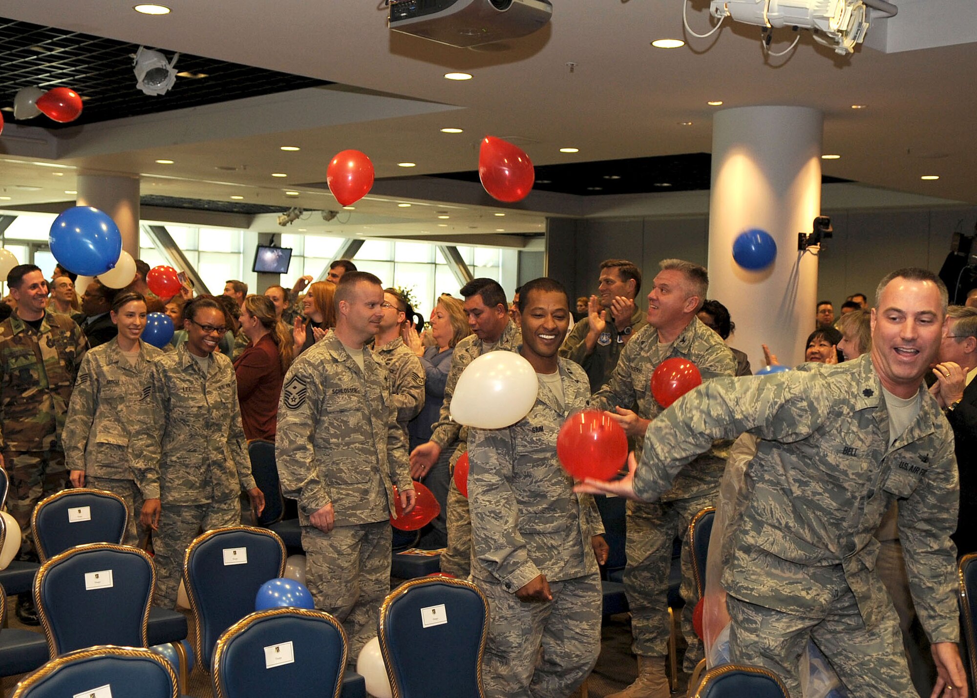 Los Angeles Air Force Base members, who recently returned from deployment, are welcomed with applause and balloons from the crowd inside Los Angeles AFB Gordon Conference Center at the start of the "SMC Welcome Home Airmen Celebration" ceremony, Jan. 29. (Photo by Stephen Schester)