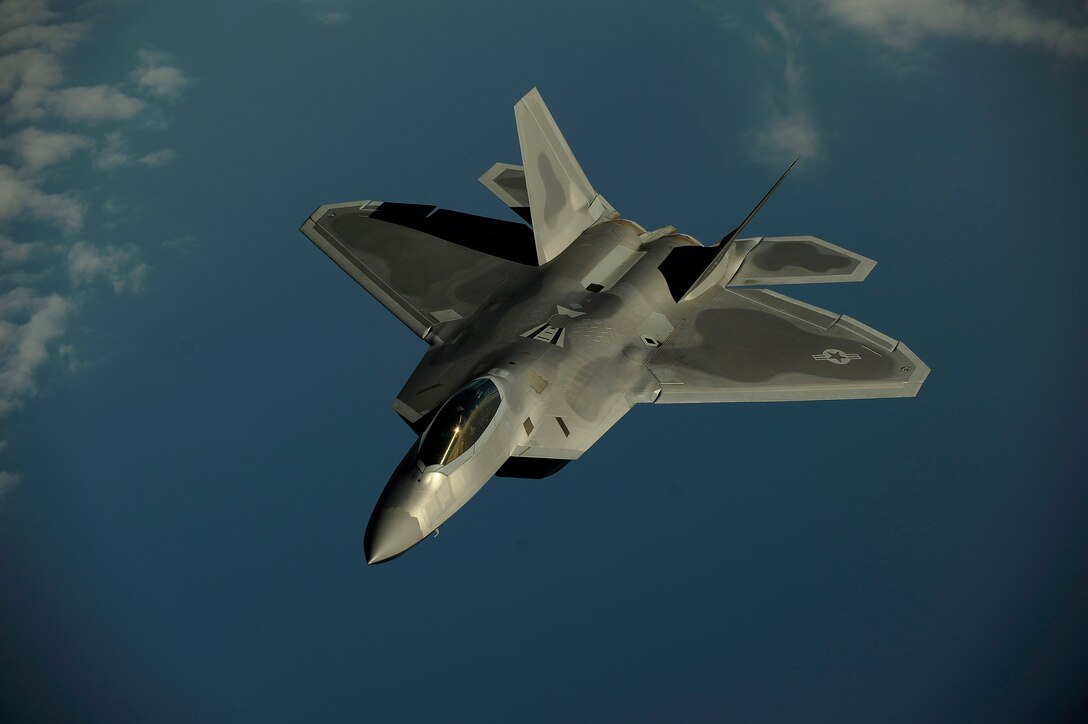 An F-22 Raptor flies over Kadena Air Base, Japan, Jan. 23 on a routine training mission.  The F-22 is deployed from the 27th Fighter Squadron at Langley Air Force Base, Va. (U.S. Air Force photo/Master Sgt. Andy Dunaway)

