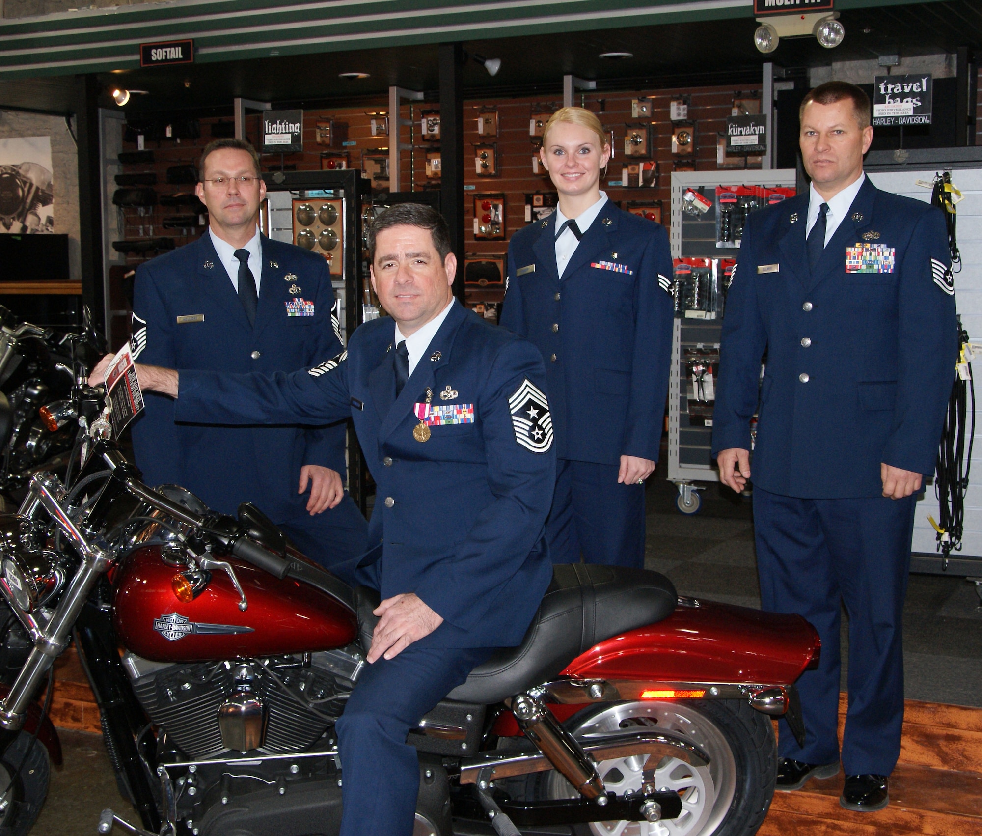 The 2008 Kansas Airmen of the Year pose with 190th ARW Command Chief Master Sgt. Brian Saunders (seated). Master Sgt. Gary Holiday (left) won the senior NCO category, Tech. Sgt. Joseph Ullmer won the NCO category and Senior Airman Olivia
Kennedy was tops in the airman category. In addition, Ullmer was named the 2008
National Guard Association of Kansas Outstanding Airman of the Year.