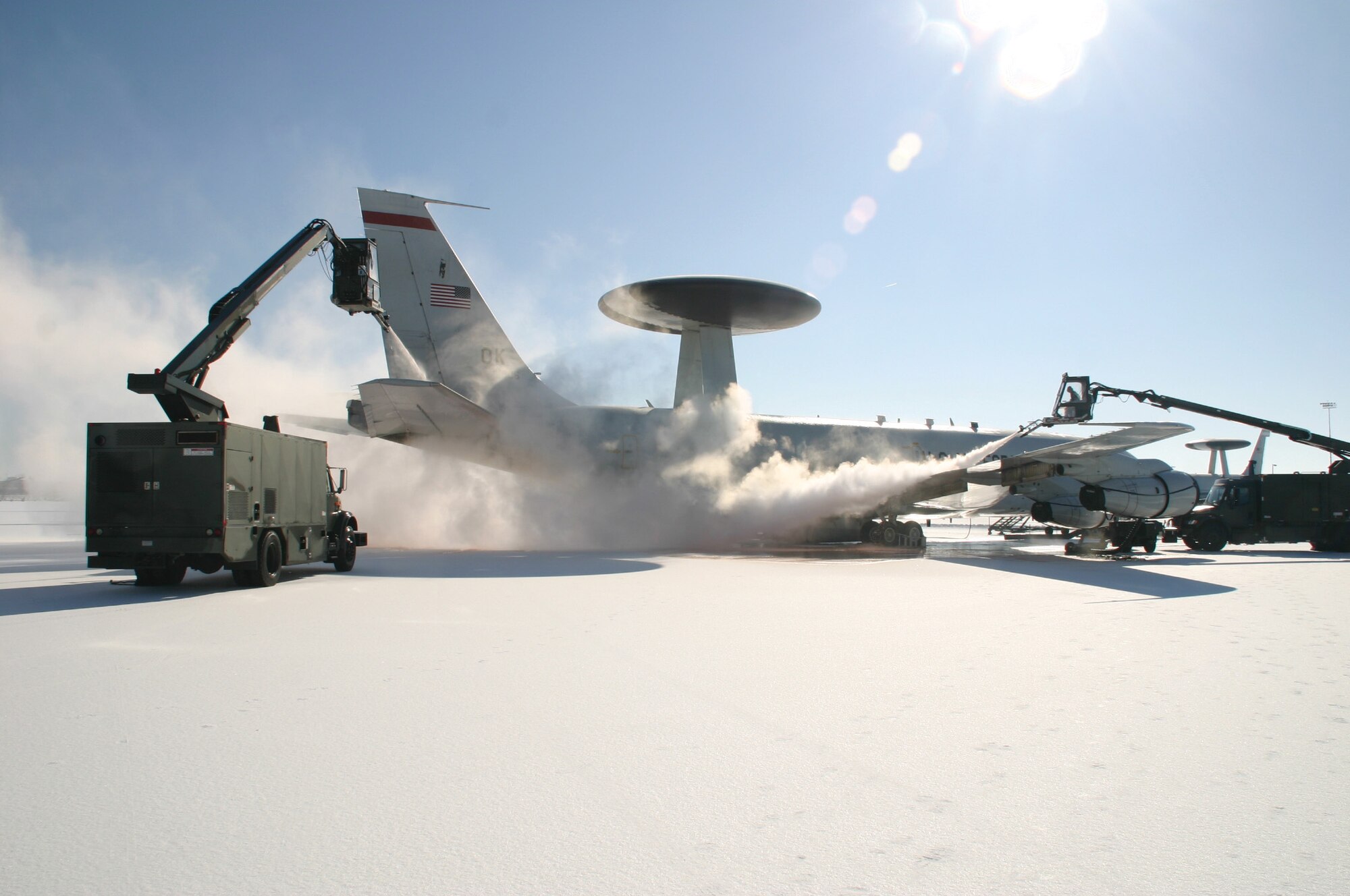 A nasty winter storm, that started Monday and ended Wednesday morning, blanketed every surface on Tinker with a layer of ice, halting non-critical operations on the base.  552nd Air Control Wing crews were hard at work Wednesday morning de-icing jets. Across the installation, work crews cleared the ice and snow so operations could safely continue.(Air Force photo/1st Lt. Kinder Blacke)