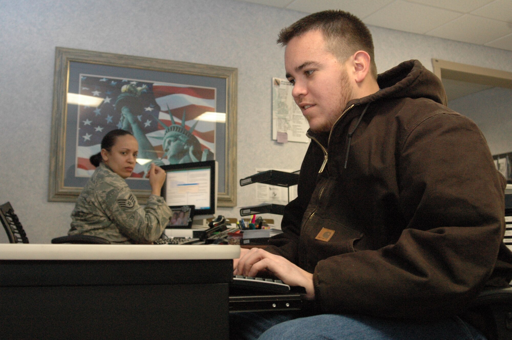 Contractor Steven Wallace uses the new electronic sign-in system at the ID card customer service section.(Air Force photo/Micah Garbarino) 