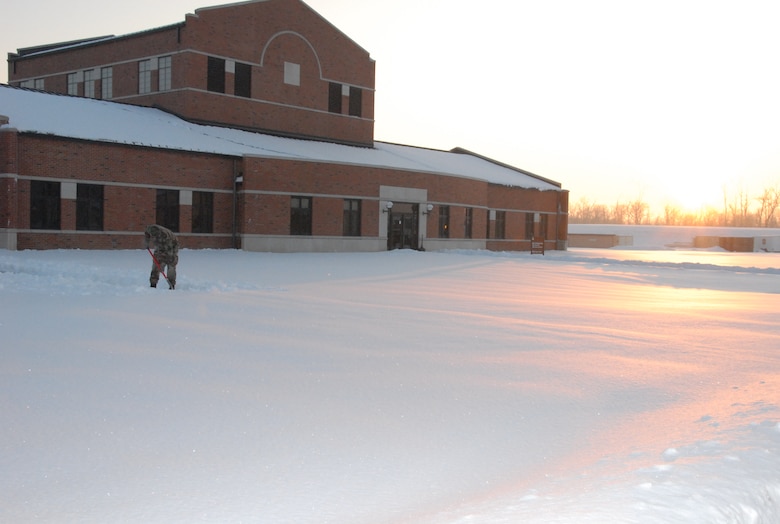 SCOTT AIR FORCE BASE, Ill. - Tech. Sgt. Jason Debusk, a health systems technician with the 126th Medical Group, starts his morning by shoveling the pristine canvas of snow that blanketed the grounds after a two day winter storm left the base minimally manned Jan. 27 and Jan. 28.  The 126 MDG is assigned to the 126th Air Refueling Wing at Scott AFB, Ill., and is part of the Illinois Air National Guard. (U.S. Air Force photo by Staff Sgt. Jessica Briney)