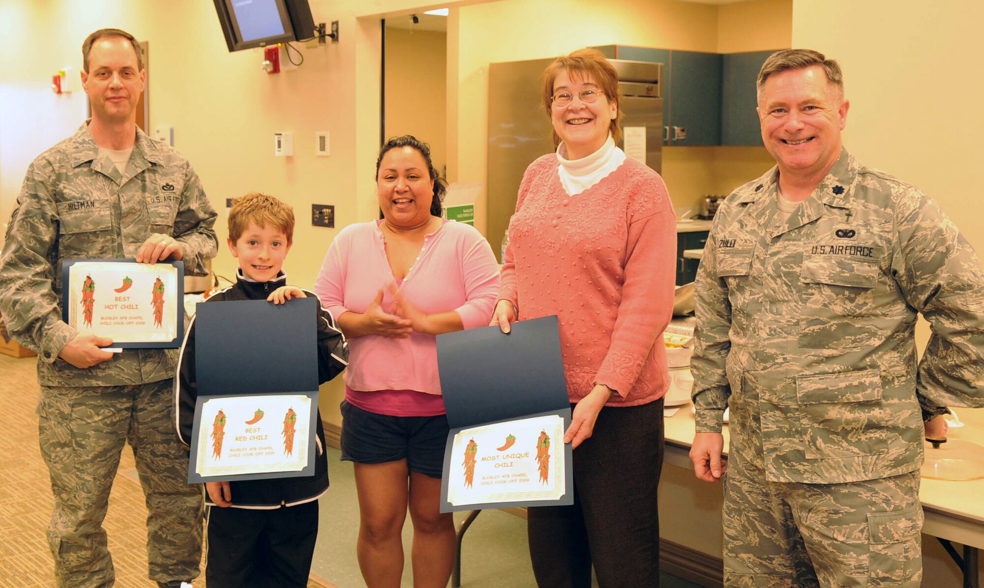 BUCKLEY AIR FORCE BASE, Colo. -- From left to right, Master Sgt. Rick Hiltman, 460th Civil Engineer Squadron first sergeant, Best Hot Chili; Master David Zulli accepting on behalf of his mother Cindy Zulli for Best Red Chili; Mrs. Anna Marie Armstrong, Chief Master Sgt. Dale Armstrong's wife, Best Green Chili, Best Overall Chili, People's Choice Chili and Best Cornbread; retired Master Sgt. Ms. Cathy Ingraham, Most Unique Chili; and Chaplain (Lt. Col.) Dan Zulli, 460th Space Wing Chaplain. The base chapel held its Sixth Annual Chili Cook-Off on Jan. 21. (U.S. Air Force photo by Senior Airman Christopher Bush)
