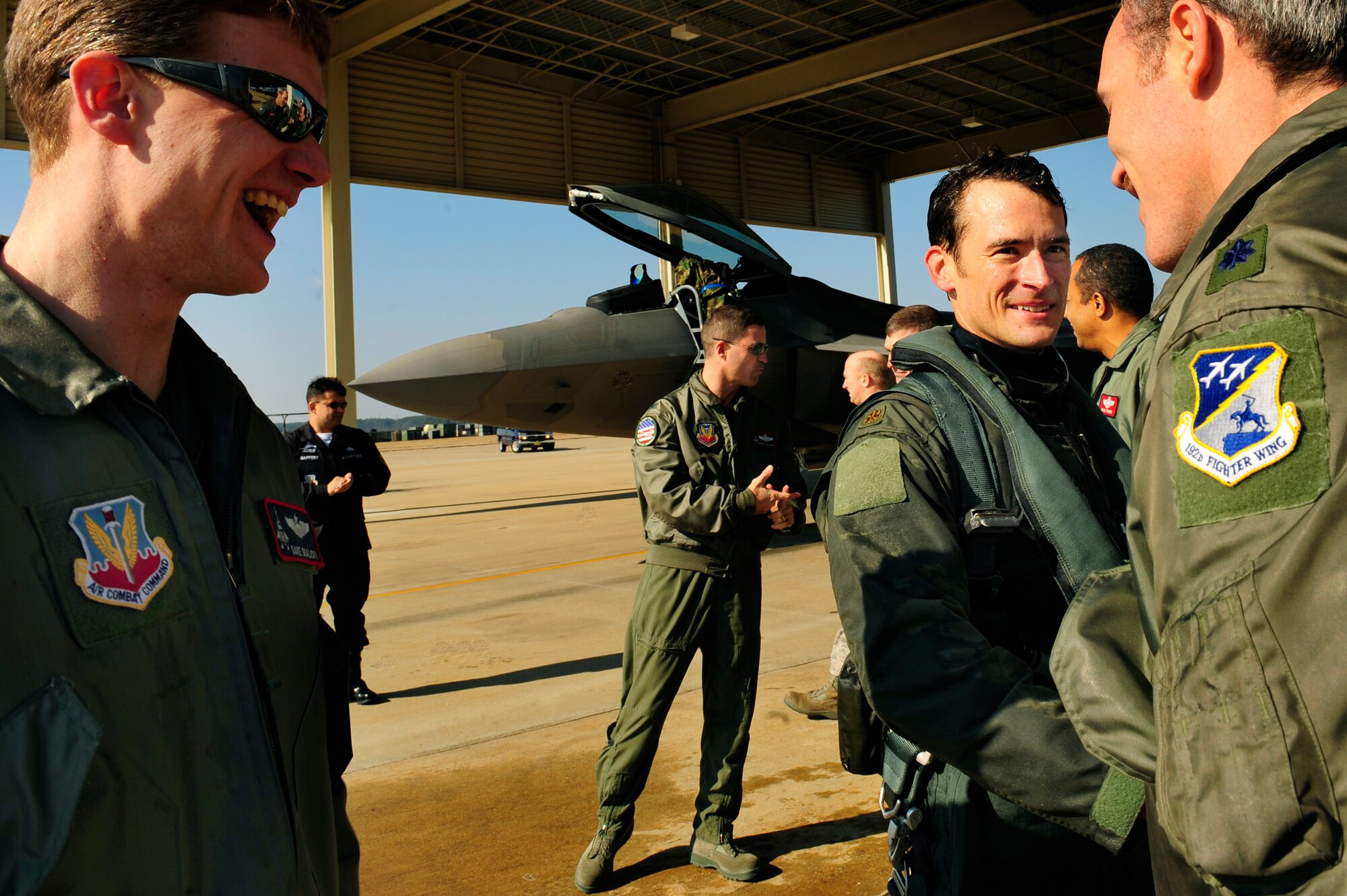 LANGLEY AIR FORCE BASE, Va. -- Maj. Paul "Max" Moga, F-22A Raptor Demonstration team pilot, is congratulated after his final flight as the official demo team pilot Jan. 29. Hampton Roads Air Force Week begins April 18, and the 2009 F-22A Demonstration Team pilot is Maj. Dave "Zeke" Skalicky, who will perform here for AirPower over Hampton Roads April 24 to 26. (U.S. Air Force photo/Senior Airman Vernon Young)