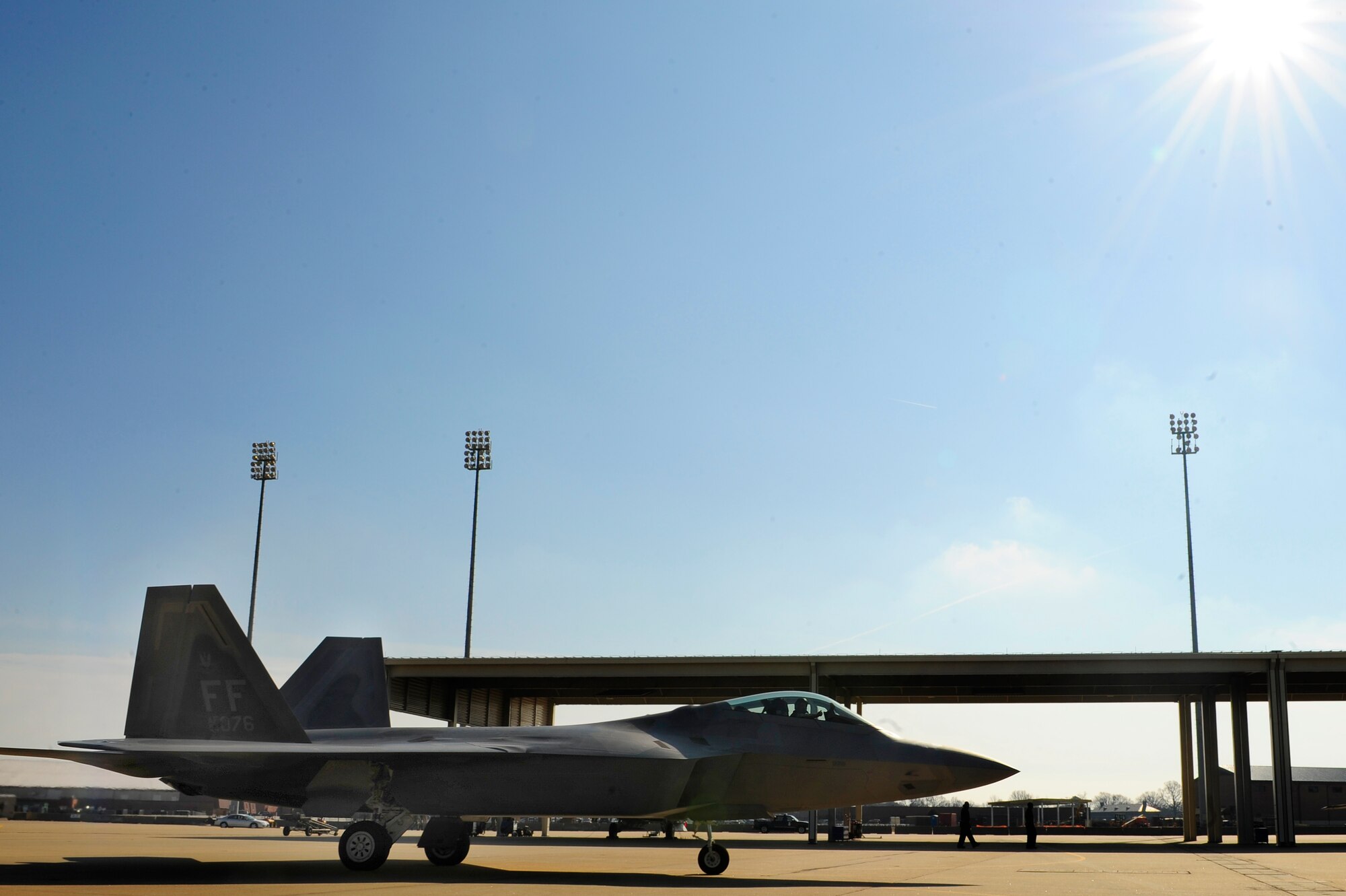 LANGLEY AIR FORCE BASE, Va. -- Maj. Paul "Max" Moga, F-22A Raptor Demonstration Team pilot, guides an F-22A Raptor into the jet hangars during his final flight Jan. 29. Hampton Roads Air Force Week begins April 18, and the 2009 F-22A Demonstration Team pilot is Maj. Dave "Zeke" Skalicky, who will perform here for AirPower over Hampton Roads April 24 to 26. (U.S. Air Force photo/Senior Airman Vernon Young)