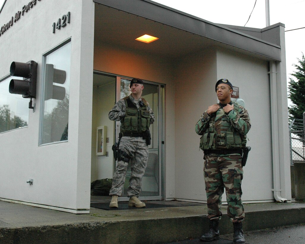 Reservist Senior Airman Terralle Moore, (right), 446th Security Forces Squadron, mans the North Gate at JBLM McChord Field, Wash., with Airman First Class Joseph Brock, 62nd Security Forces Squadron on Jan. 11, 2009. As part of the 446th Airlift Wing's efforts to ease traffic woes at the main gate on primary drill weekends, both the North Gate and the Housing Gate will be open from 6 to 9 a.m. and 11 a.m. to 1 p.m.  The north gate is adjacent to the 62nd Aerial Port Squadron building and is accessible from Highway 512 at the Steele street exit. The housing gate is accessible from the Gravelly Lake Drive exit from I-5. (U.S. Air Force photo/Staff Sgt. Grant Saylor)
