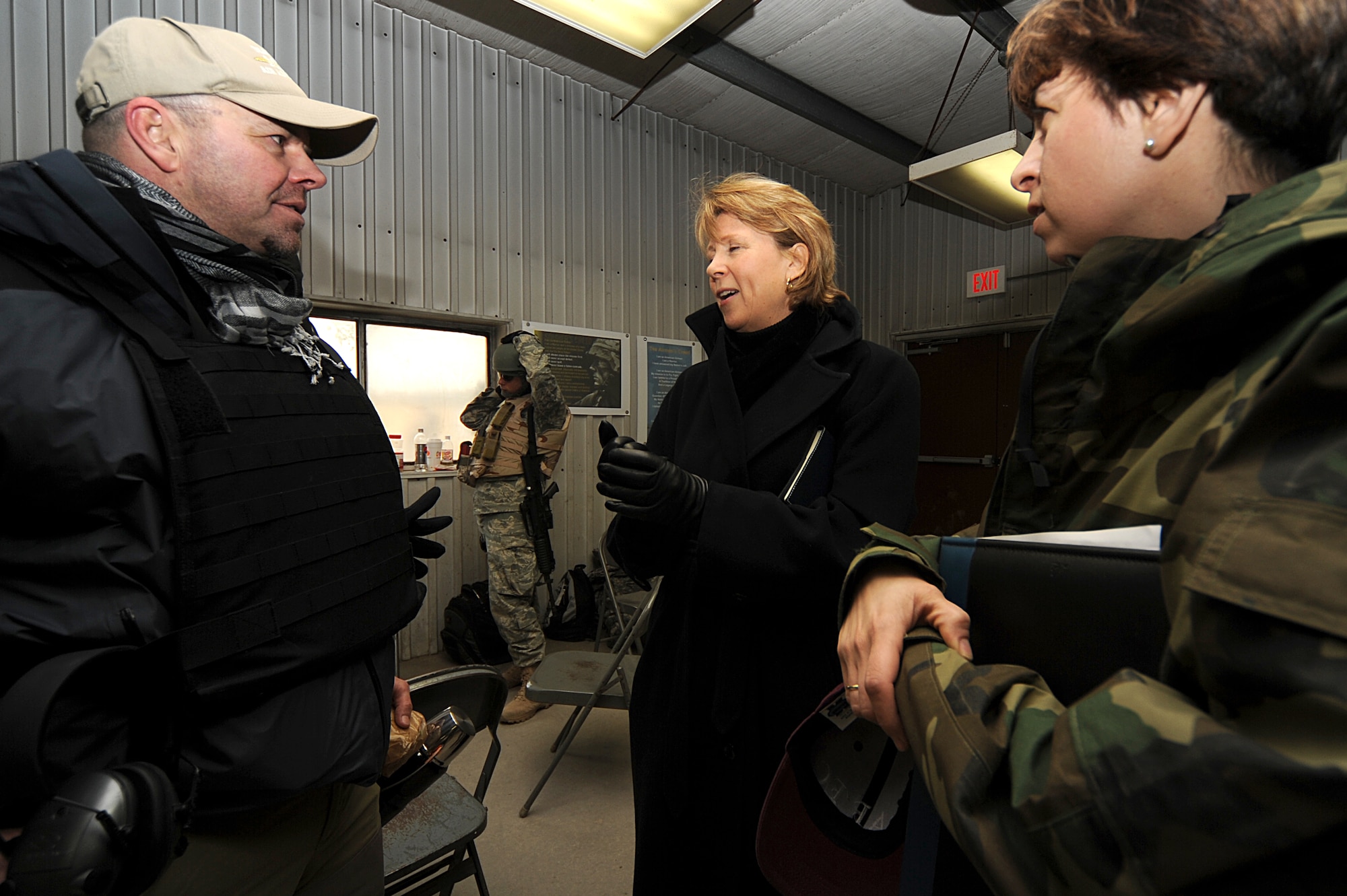Ms. Elisabeth Bumiller, New York Times reporter, escorted by Lt. Col. Christie Dragon, director of U.S Air Force Expeditionary Center Public Affairs, meets with Christopher Teeple, Military Professional Resources Incorporated, before interviewing Airmen from the Air Advisor Course, hosted by the Expeditionary Center, about their upcoming deployments at a range on Fort Dix, N.J., Jan. 27.  The Air Advisor Course is a combined effort between USAFEC, AETC, AFCENT and contractors to prepare Airmen deploying to Iraq and Afghanistan to train air force members in those countries.  (U.S. Air Force Photo/Staff Sgt. Nathan Bevier)