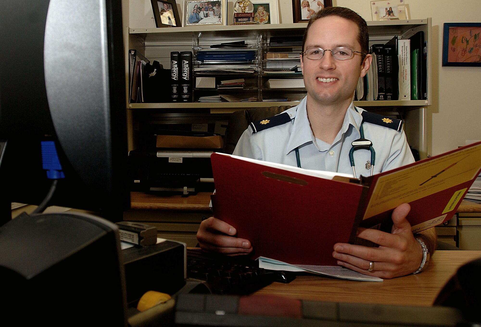 Maj. (Dr.) Christopher Calabria reviews a patient's immunology records Jan. 26.  Dr. Calabria was selected for an American Academy of Allergy, Asthma and Immunology Award that recognizes outstanding research published by a developing researcher. Dr. Calabria is the officer in charge of the Wilford Hall Medical Center Immunizations Clinic. (U.S. Air Force photo/Senior Airman Josie Kemp) 