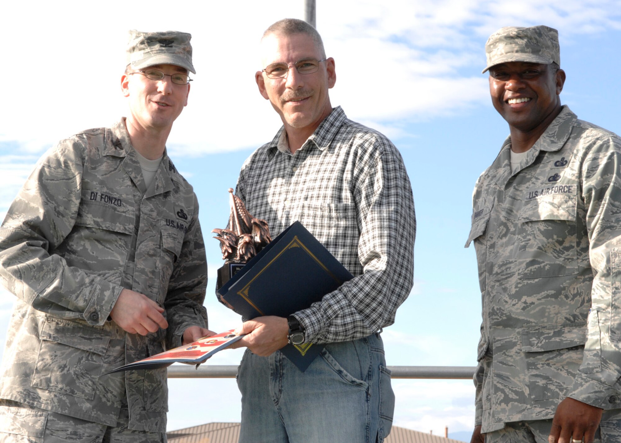 Mr. McKee, 49th Communications Squadron, wins in the civilian category two at the 49th Mission Support Group's annual awards formation ceremony,  Jan. 23 at Holloman Air Force Base, N.M. The award is presented by Col. Stephen Difonzo, 49th MSG commander and Chief Master Sgt. Jerome Baker, 49th MSG superintendent.(U.S. Air Force photo/Airman 1st Class Rachel A. Kocin)