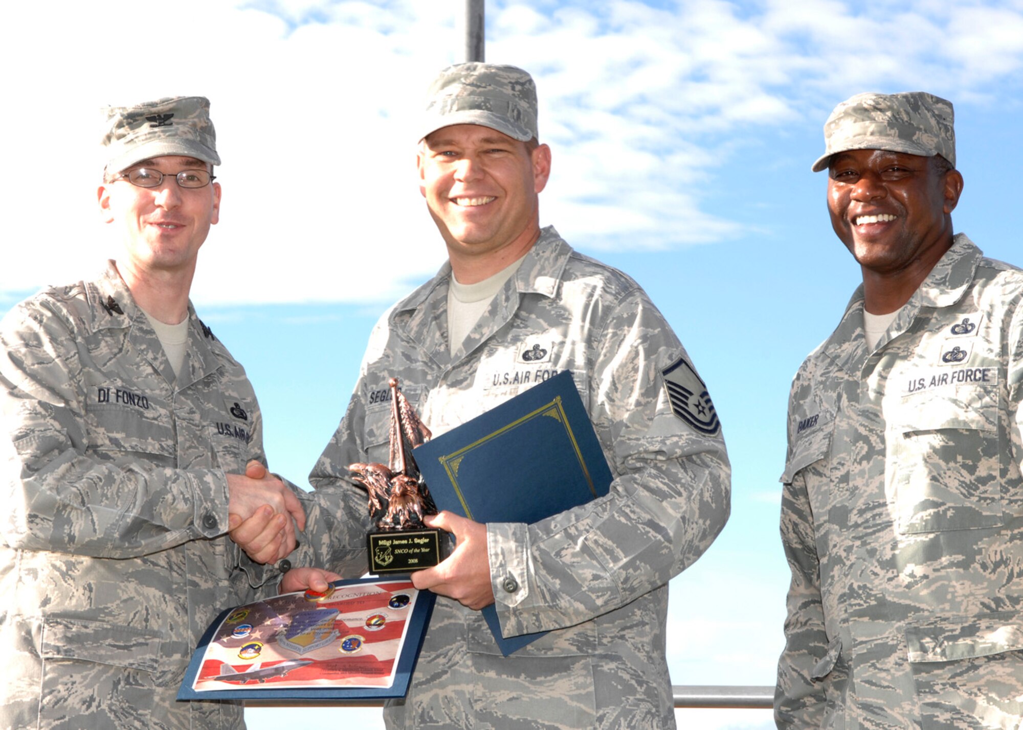 Master Sgt. James Segler, 49th Force Support Squadron, wins in the senior non-commissioned officer category at the 49th Mission Support Group's annual awards formation ceremony, Jan. 23 at Holloman Air Force Base, N.M. The award is presented by Col. Stephen Difonzo, 49th MSG commander and Chief Master Sgt. Jerome Baker, 49th MSG superintendent. (U.S. Air Force photo/Airman 1st Class Rachel A. Kocin)