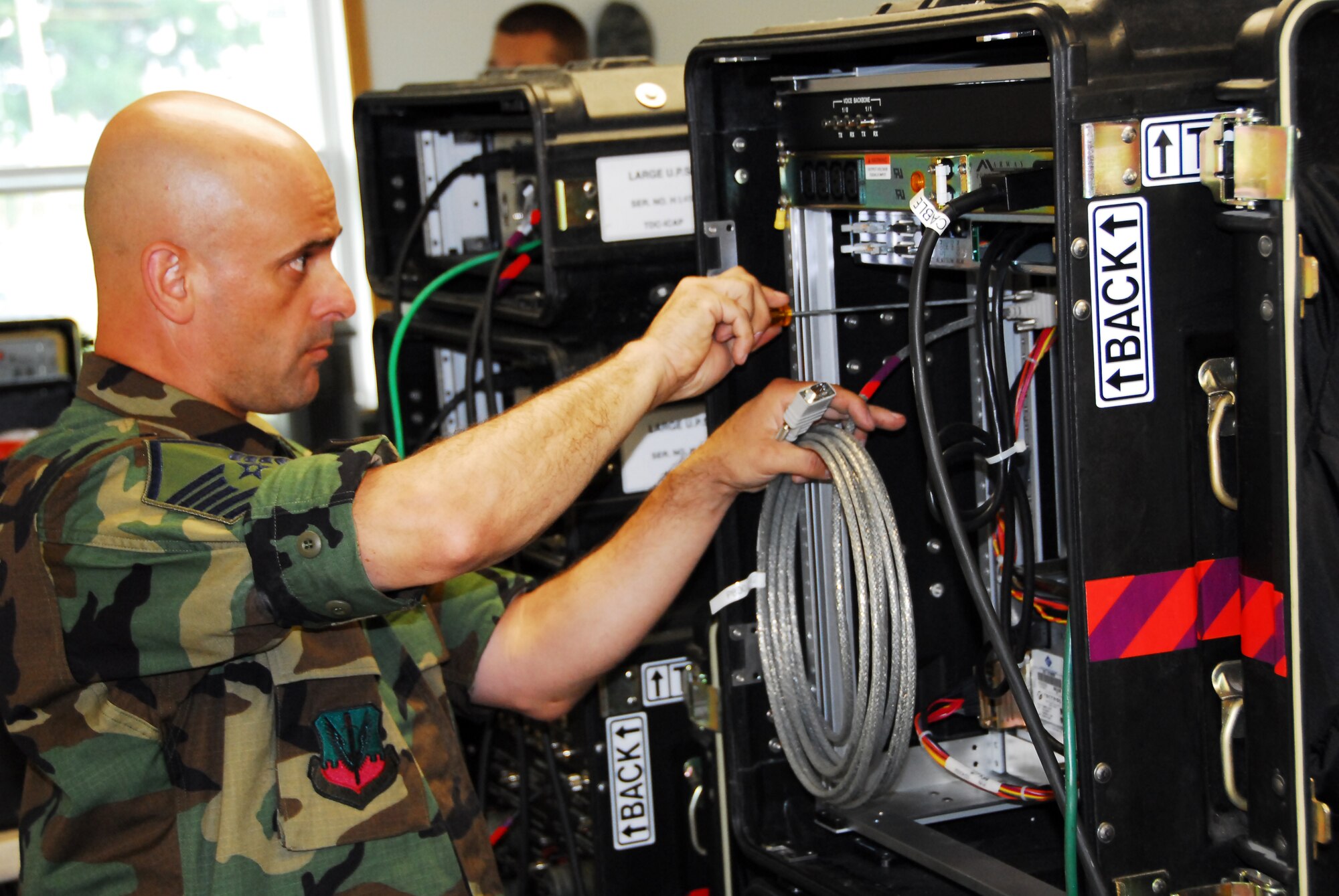 MSsgt Robert Blandy, Information Technology Specialist with the 271st Combat Communications Squadron assembles a piece of radio receiving equipment for the unit during the Golbal Patriot 08 exercise at Volk Field WI. This is one of many work stations Blandy will supervise when all are assemble and on line.