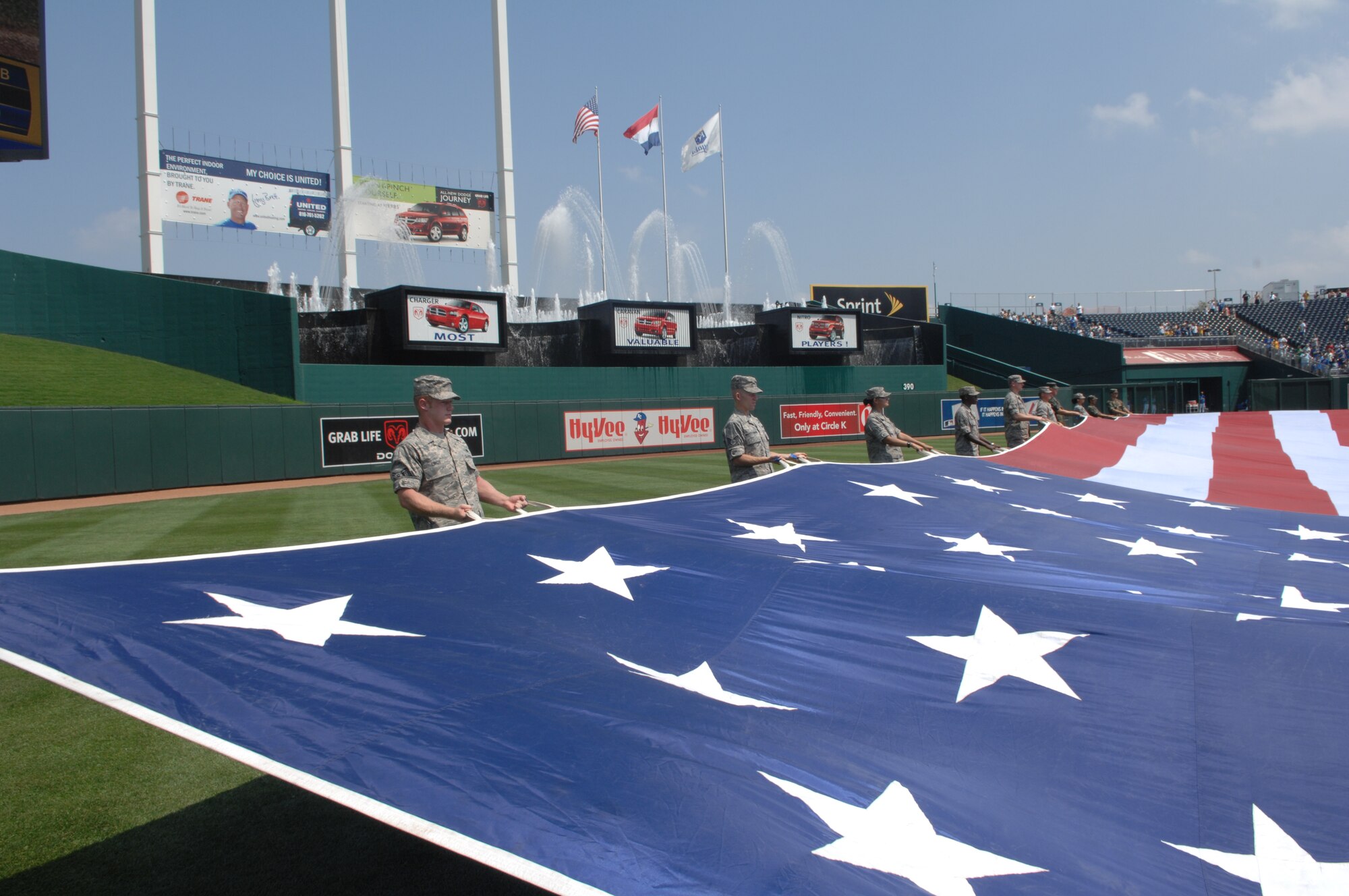 WHITEMAN AIR FORCE BASE, Mo. - Members of Team Whiteman participate in the Kansas City Royals Military Appreciation Day Aug. 2 by holding a large American Flag on the field during the National Anthem. (U.S. Air Force photo/Senior Airman Jessica Snow)