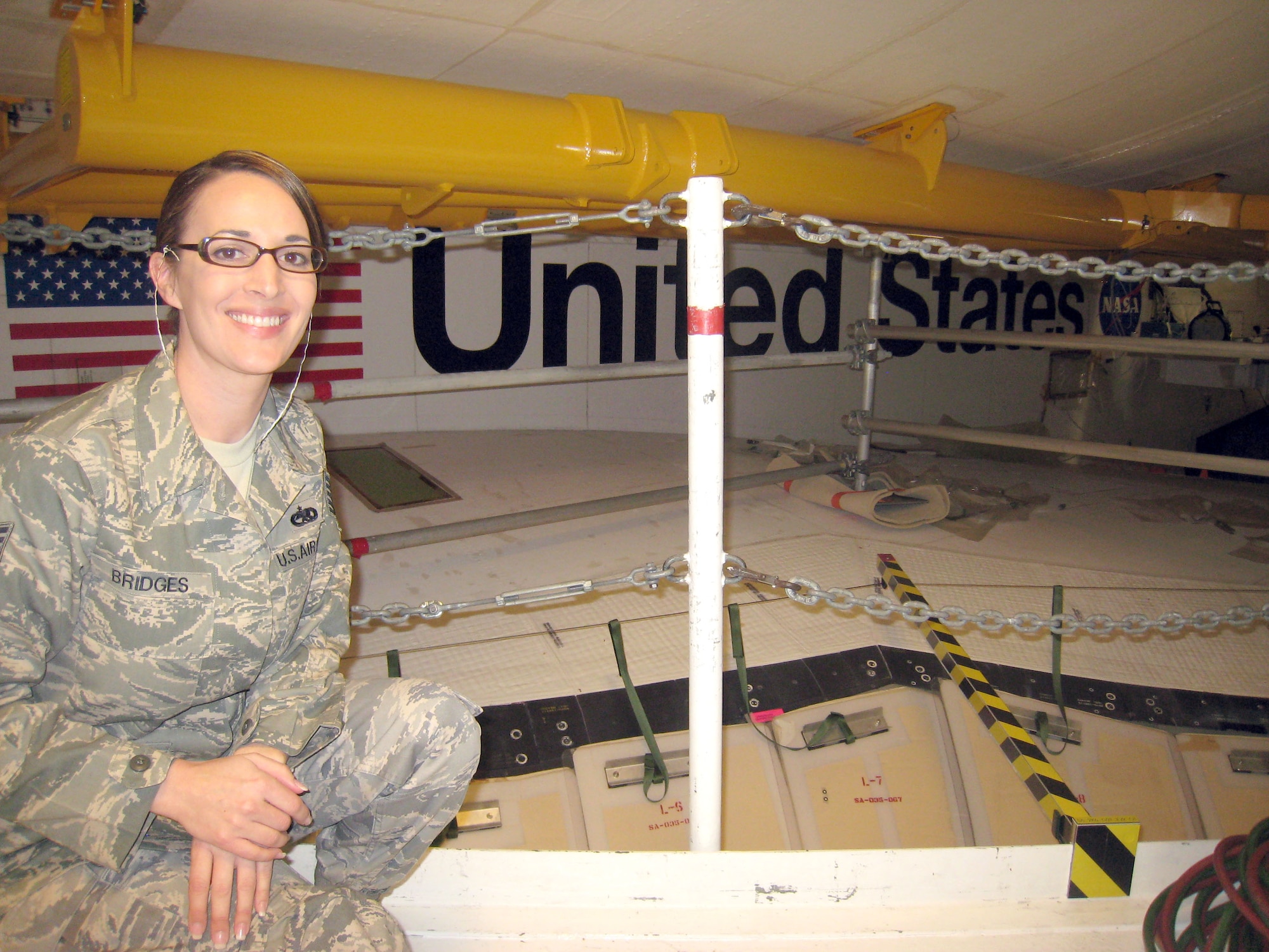 Tech. Sgt. Lori Bridges pauses for a moment during a recent tour of Kennedy Space Center facilities in Florida. She along with Master Sgt. Sean Murphy and Staff Sgt. Michael Huesca received a personal tour of the space center after earning top recruiter honors for the 333rd Recruiting Squadron for December. As part of the tour hosted by Detachment 3 of the 45th Operations Group at Patrick Air Force Base, the three viewed the vertical processing facility, orbiter processing facility with the Orbiter Atlantis inside as well the “Crawler” and one of the space shuttle launch pads. (Courtesy photo)