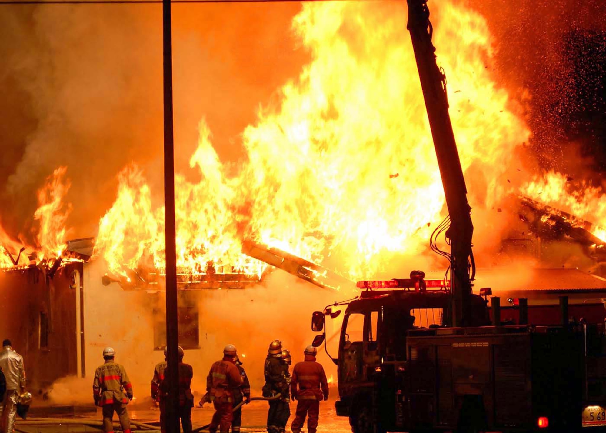 Firefighters from the 374th Civil Engineer Squadron and the Tokyo Metropolitan Fire Department work together to fight a fire at the Defense Finance and Accounting Service Japan building that caught fire at about 6:30 p.m. Jan. 20 at Yokota Air Base, Japan. (U.S. Air Force photo/Airman Sean Martin) 

