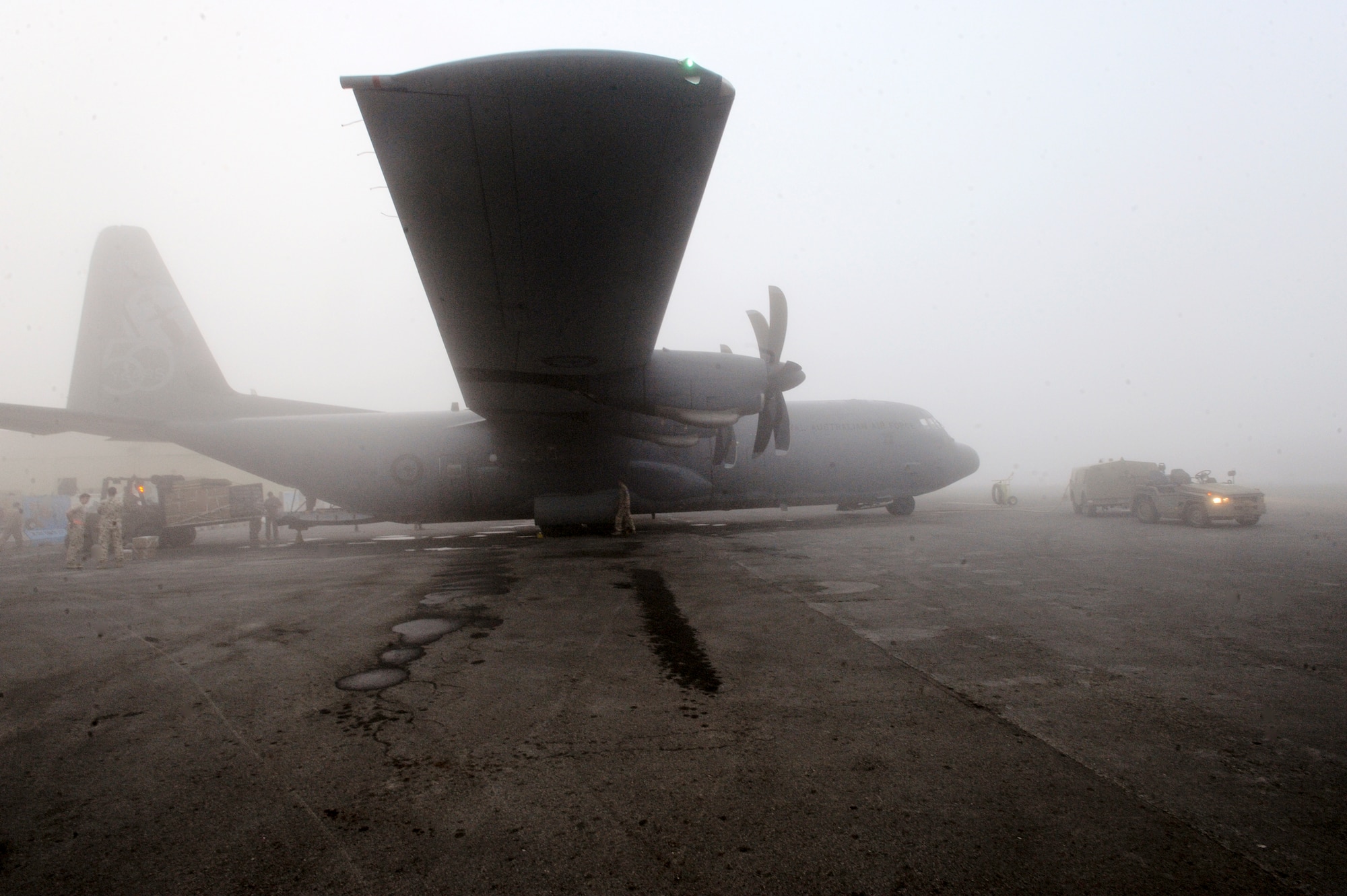 Members of the Royal Australian Air Force load a C130J Hercules with cargo to resupply Australian forces in Afghanistan, Jan. 29, 2009 at an undisclosed location in Southwest Asia.  The RAAF fly support missions around the area of responsibility providing Coalition Forces with needed supplies.  The members of the RAAF are deployed in support of Operations Iraqi and Enduring Freedom and Combined Joint Task Force - Horn of Africa. (U.S. Air Force Photo by Staff Sgt. Joshua Garcia/released)