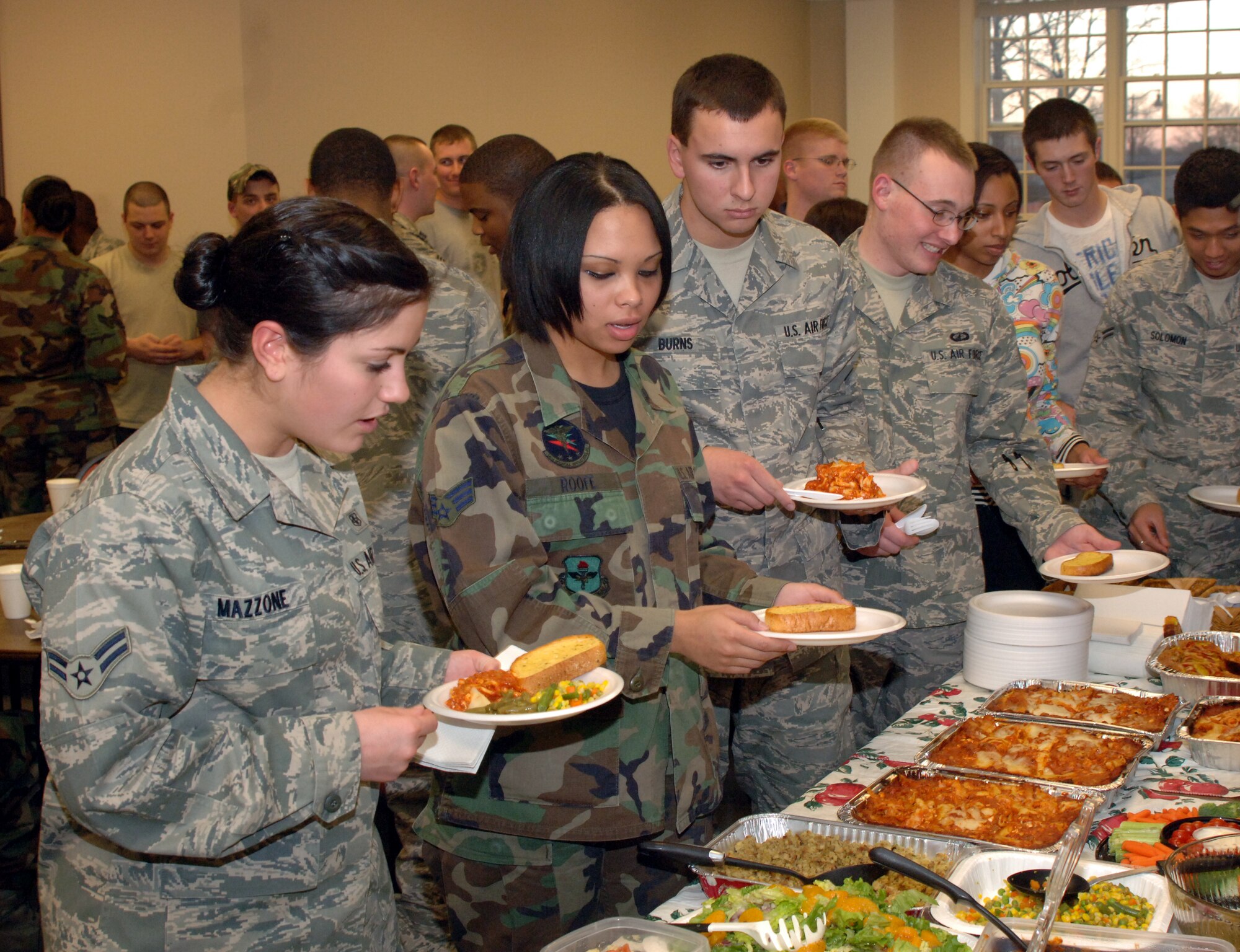 Enlisted dormitory residents browse through the buffet line at the Dorm Dinner held Jan. 22 at the Chapel Annex. This dinner was hosted by senior leaders of Columbus AFB. During the dinner, the new enlisted Dormitory Council held a vote to elect its new members. (U.S. Air Force photo by Airman 1st Class Josh Harbin)