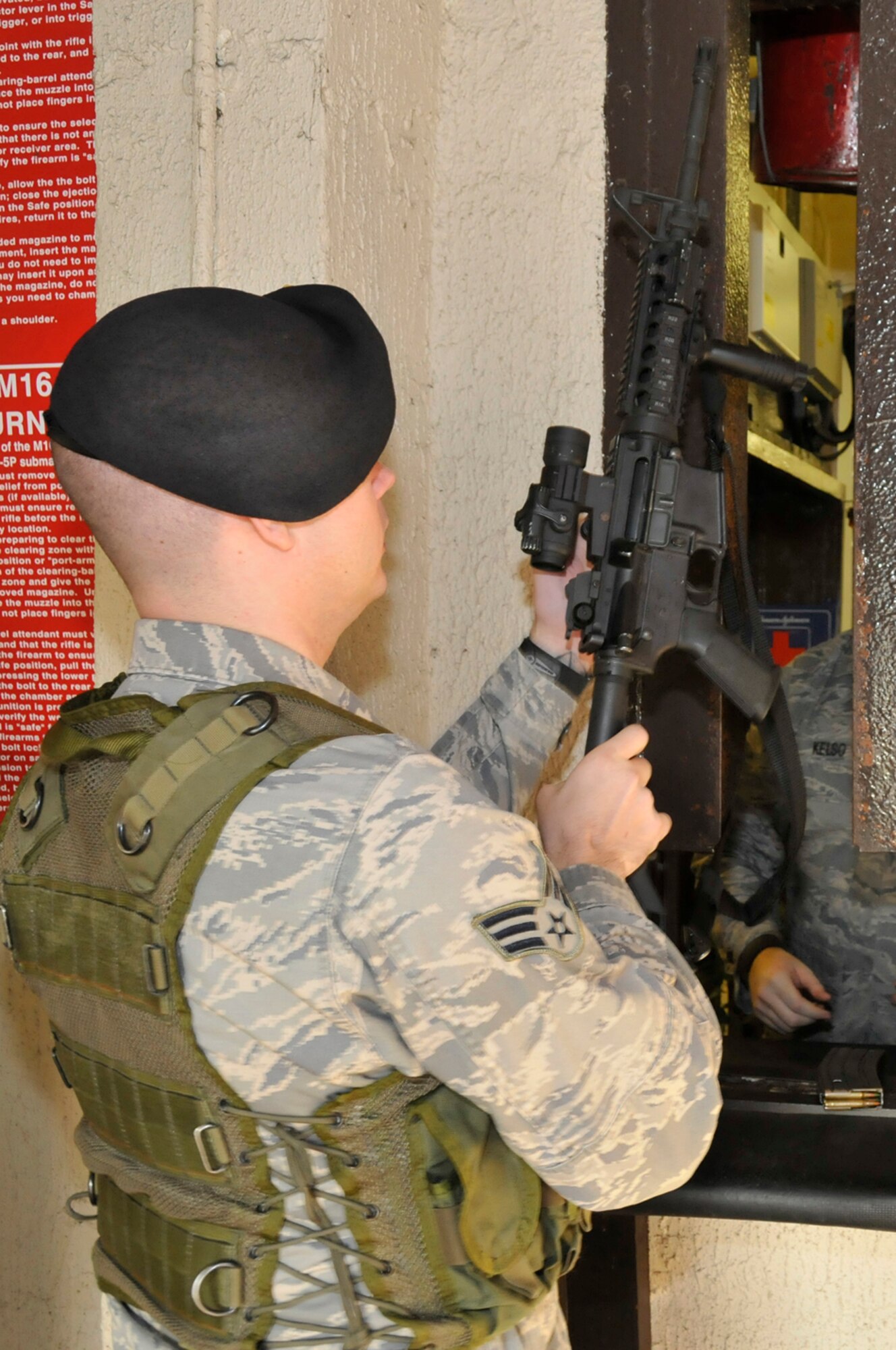 Senior Airman Craig Sams, 48th Secuirty Forces Squadron, recives an M4A1 Assault Rifle from Senior Airman Jeremy Kelso, 48th Secuirty Forces Squadron armors, Jan. 27 at RAF Lakenheath, England. The Security Forces Armory is manned 24 hours a day, seven days week. (U.S. Air Force photo by Airman 1st Class Perry Aston) 