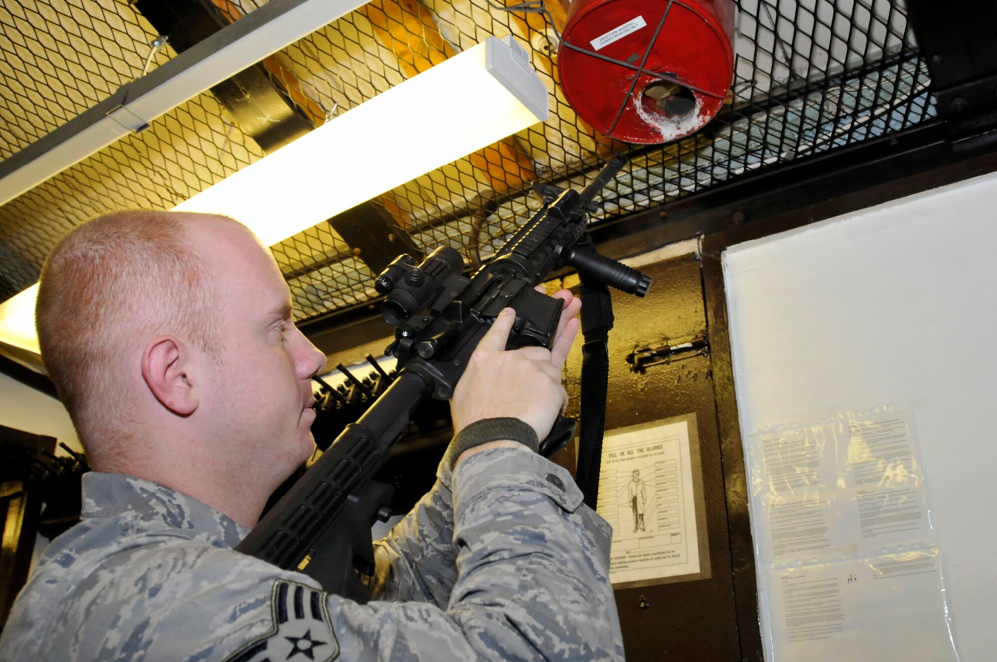 Senior Airman Jeremy Kelso, 48th Security Forces Squadron armors, checks an M4A1 Assault Rifle's breech for any live rounds before issuing the weapon Jan. 27 at RAF Lakenheath, England. The Security Forces Armory is manned 24 hours a day, seven days a week. (U.S. Air Force photo by Airman 1st Class Perry Aston)