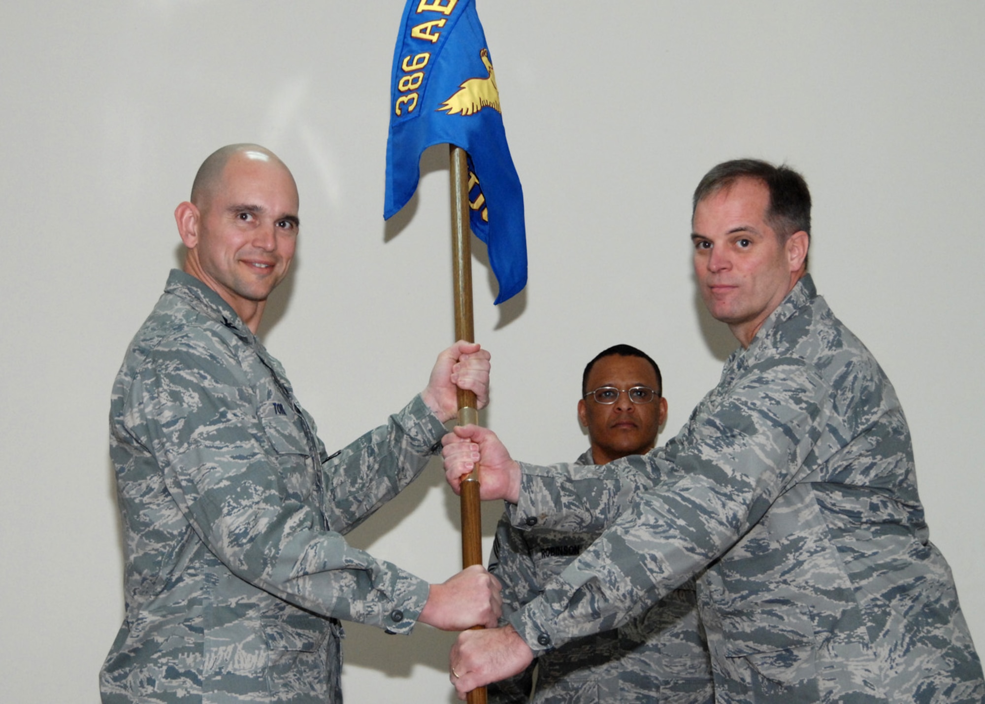 SOUTHWEST ASIA -- Col. Cameron Torrens, 386th Air Expeditionary Wing commander, gives command of the 386th Expeditionary Medical Group to Col. James King at an air base in Southwest Asia, Jan. 29. Colonel King serves as the Deputy Command Surgeon at Wright-Patterson Air Force Base, Ohio. (U.S. Air Force photo/Senior Airman Courtney Richardson)