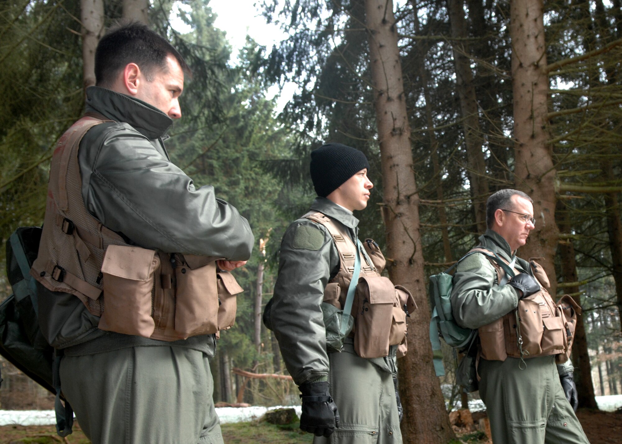 SPANGDAHLEM AIR BASE, Germany -- (left to right) Majs. Scott Hurrelbrink, 81st Fighter Squadron, and Wilford Kauffman, 23rd Fighter Squadron and Col. Patrick McCrea, 52nd Operations Group Commander, listen to instructions given during Combat Survival Training, Jan. 26, 2009. The CST program is a fast paced two-day refresher course that provides pilots with the skills to return home. (U.S. Air Force photo by Airman Staci Miller)