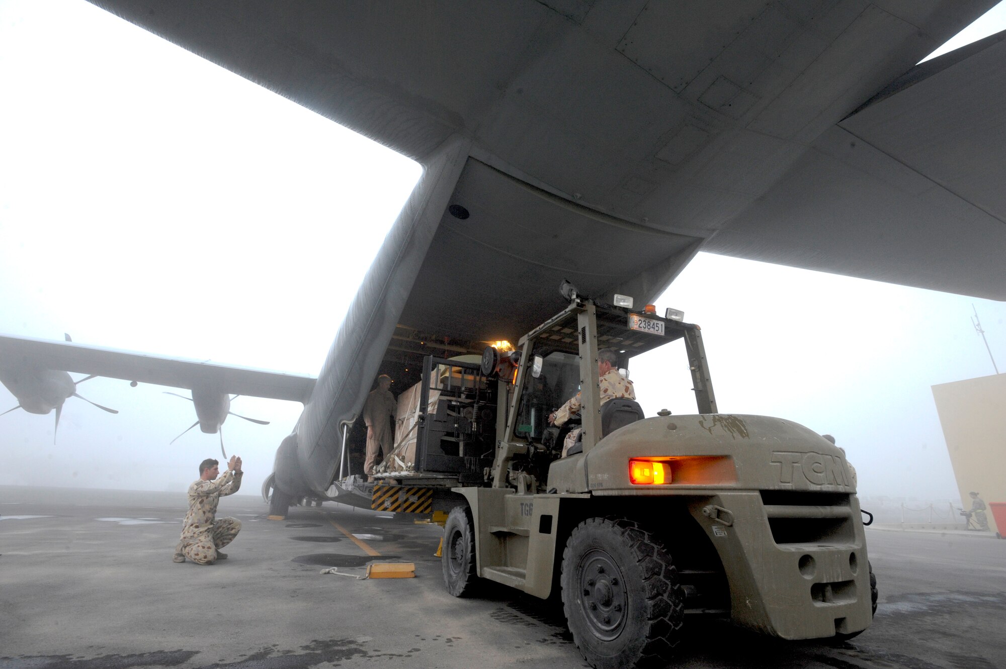 Members of the Royal Australian Air Force load a C130J Hercules with cargo to resupply Australian forces in Afghanistan, Jan. 29, 2009 at an undisclosed location in Southwest Asia.  The RAAF fly support missions around the area of responsibility providing the Coalition Forces with needed supplies.  The members of the RAAF are deployed in support of Operations Iraqi and Enduring Freedom and Combined Joint Task Force - Horn of Africa. (U.S. Air Force Photo by Staff Sgt. Joshua Garcia/released)
