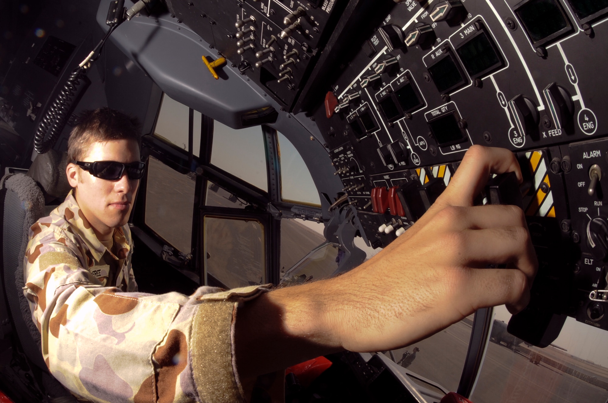 Leading Aircraftman Adam Renfree, Royal Australian Air Force, checks the fire handle and shut off valves on a C-130 Hercules, Jan. 28 2009, at an undisclosed location in Southwest Asia.  The fire handle is a safety measure that will release an extinguisher agent into the engine bay if an engine fire occurs during flight. LC Renfree is deployed in support of Operations Iraqi and Enduring Freedom and Combined Joint Task Force - Horn of Africa.  (U.S. Air Force Photo by Staff Sgt. Joshua Garcia/released)