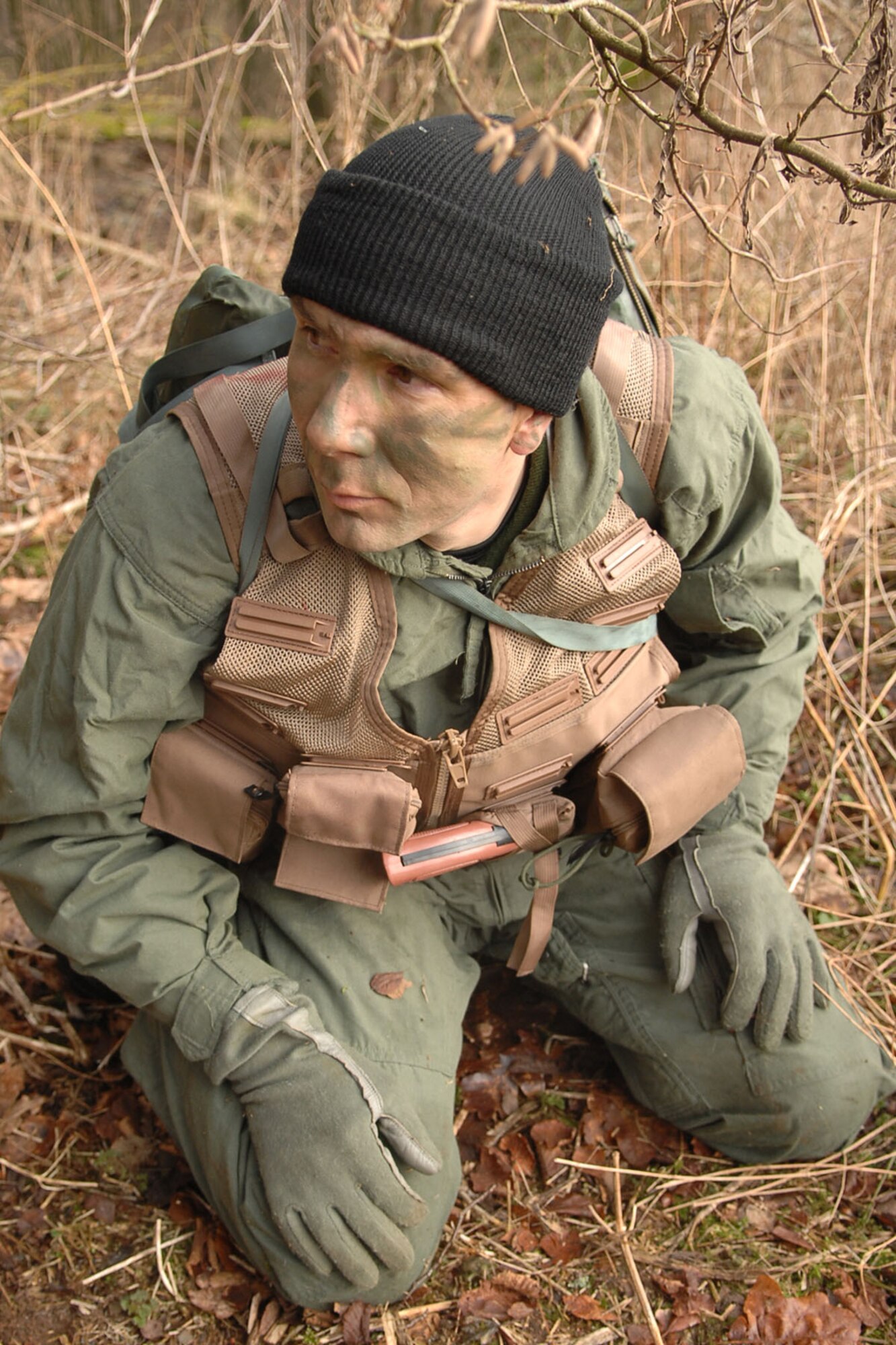 SPANGDAHLEM AIR BASE, Germany  – Staff Sgt. Robert A. Martin, 52nd Operations Support Squadron,  scans an area while trying to conceal himself  from opposing forces during a Survival Evasion Resistance and Escape training exercise Jan. 27. The purpose of the course was to offer training to evade and escape enemy forces. (U.S. Air Force photo by Airman 1st Class Nicholas Wilson)